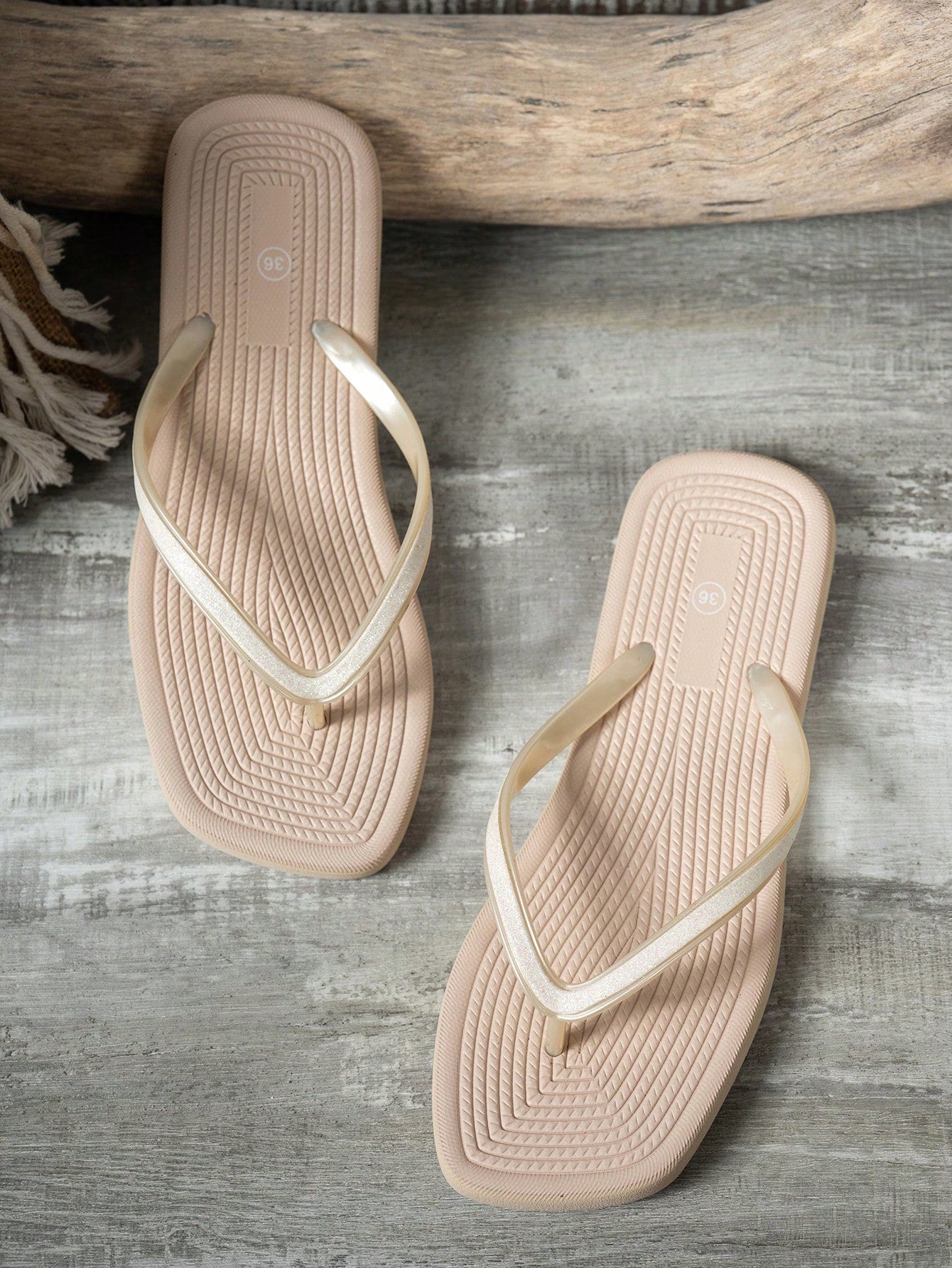 Women's solid color flip flops with open-toe design, flat sole, and cut-out details, suitable for casual indoor or outdoor wear at the beach or pool.