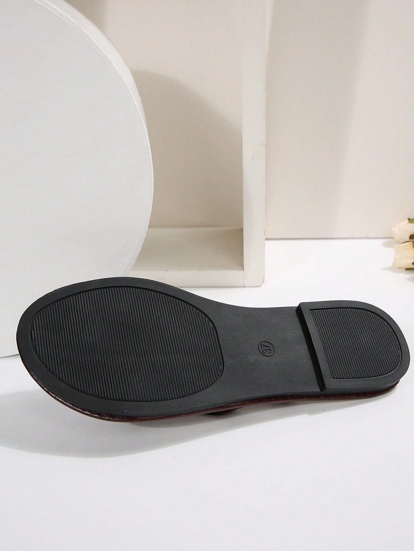 Women's chocolate brown flat flip flop sandals featuring a toe-post thong style and braided detail, suitable for casual indoor and outdoor wear.