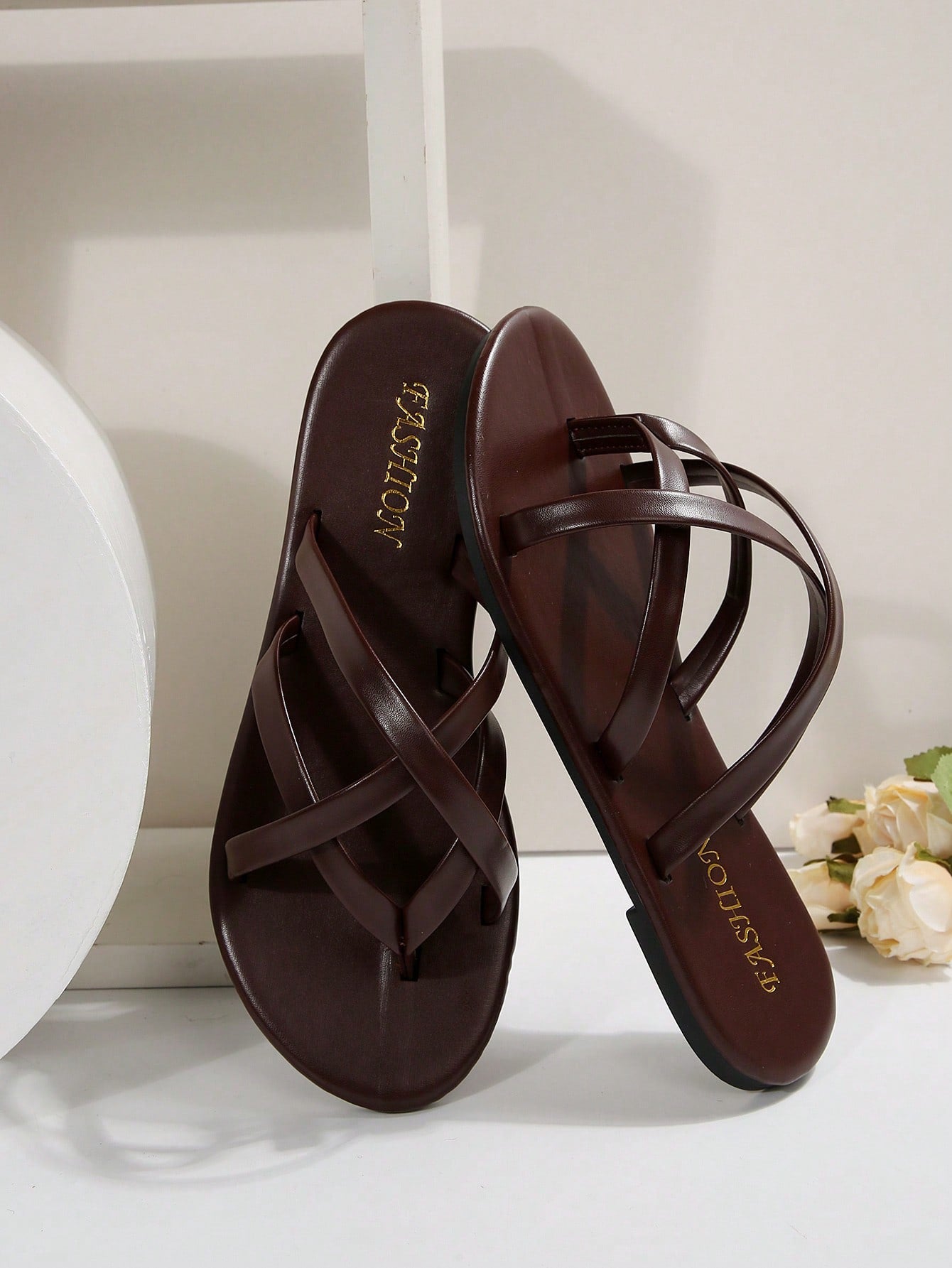Women's chocolate brown flat flip flop sandals featuring a toe-post thong style and braided detail, suitable for casual indoor and outdoor wear.