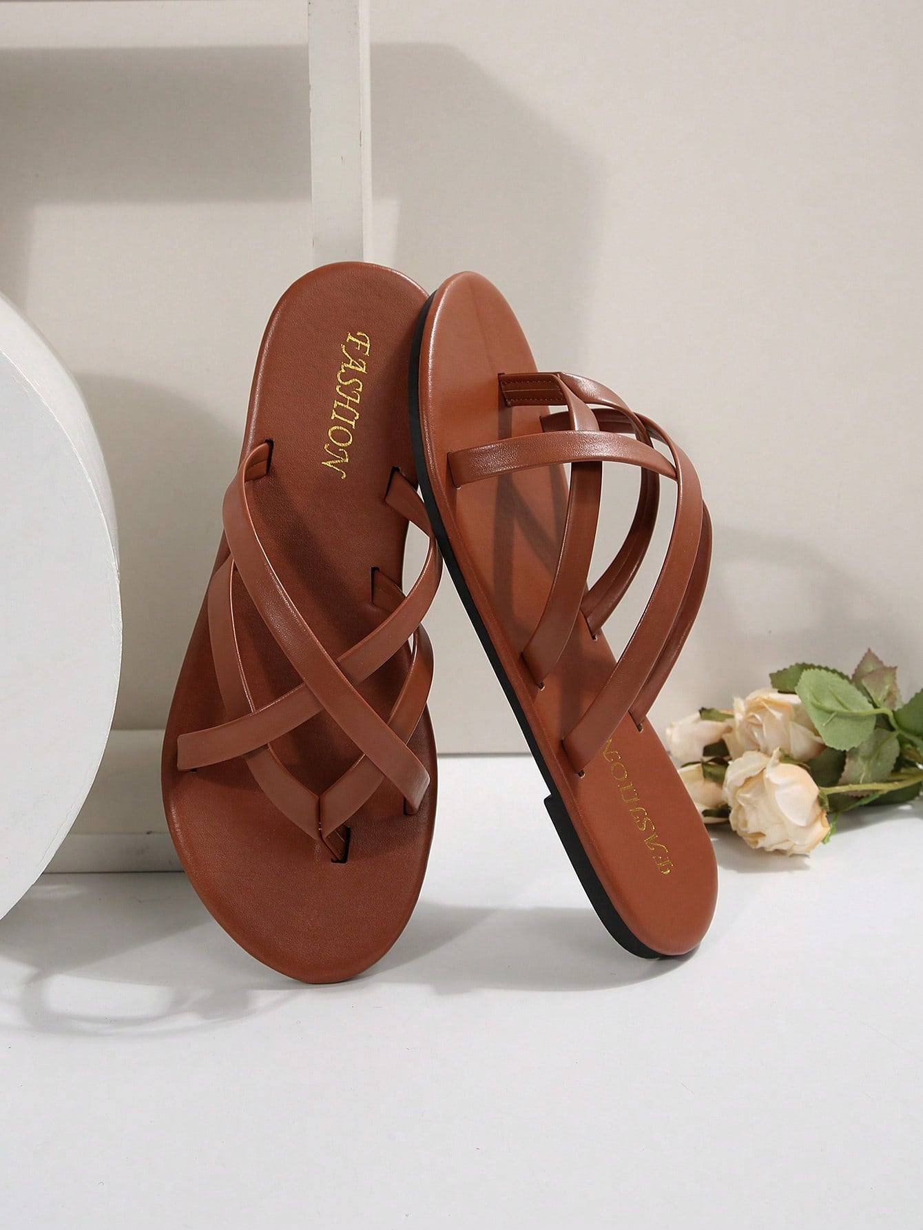 Women's chocolate brown flat flip flop sandals featuring a toe-post thong style and braided detail, suitable for casual indoor and outdoor wear.