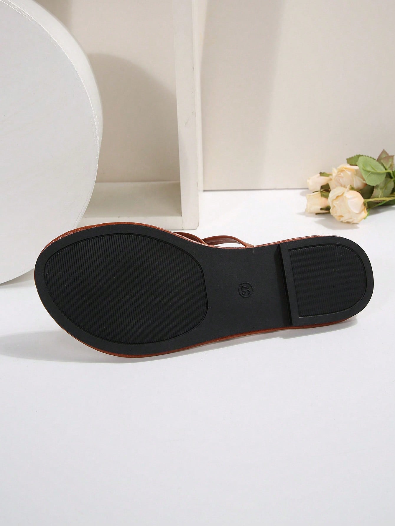 Women's chocolate brown flat flip flop sandals featuring a toe-post thong style and braided detail, suitable for casual indoor and outdoor wear.