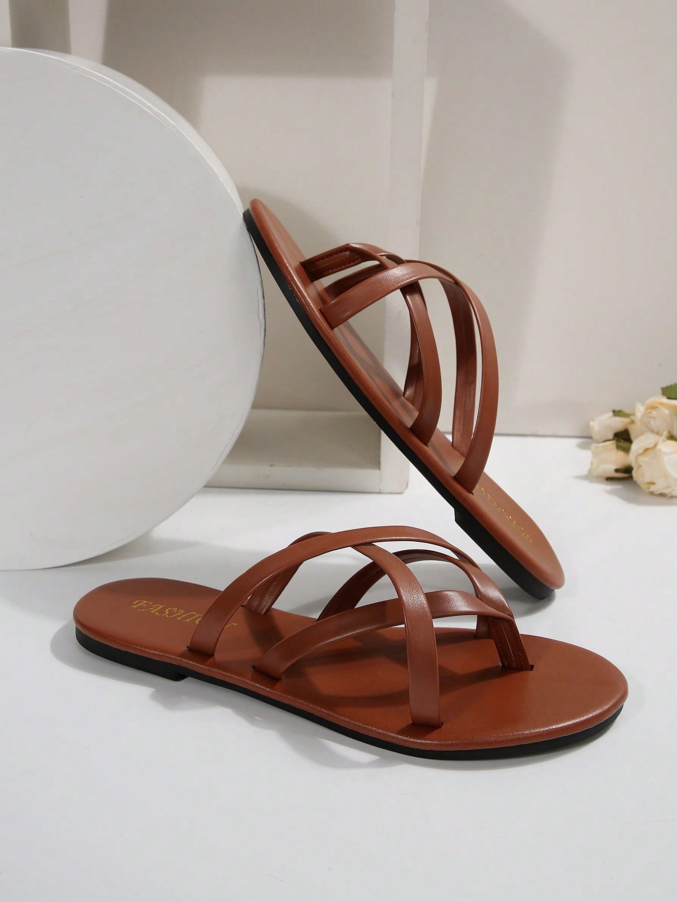 Women's chocolate brown flat flip flop sandals featuring a toe-post thong style and braided detail, suitable for casual indoor and outdoor wear.