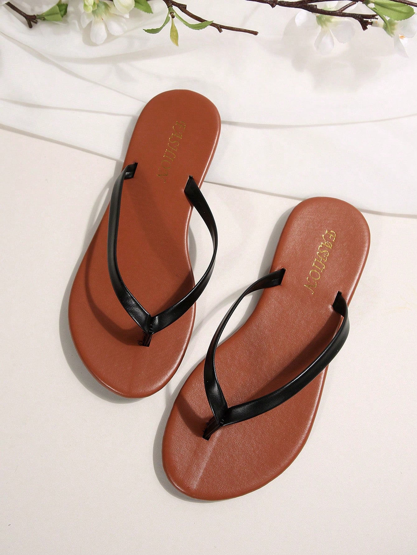 Women's chocolate brown flat flip flop sandals featuring a toe-post thong style and braided detail, suitable for casual indoor and outdoor wear.
