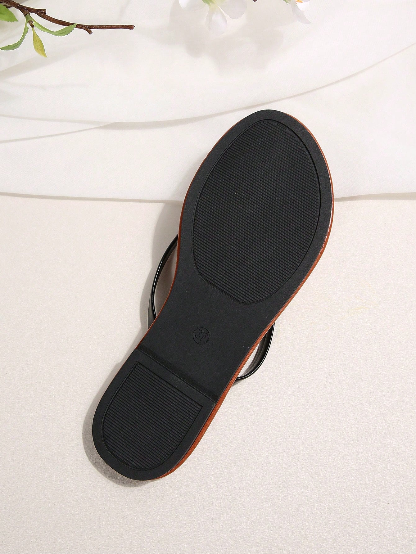 Women's chocolate brown flat flip flop sandals featuring a toe-post thong style and braided detail, suitable for casual indoor and outdoor wear.