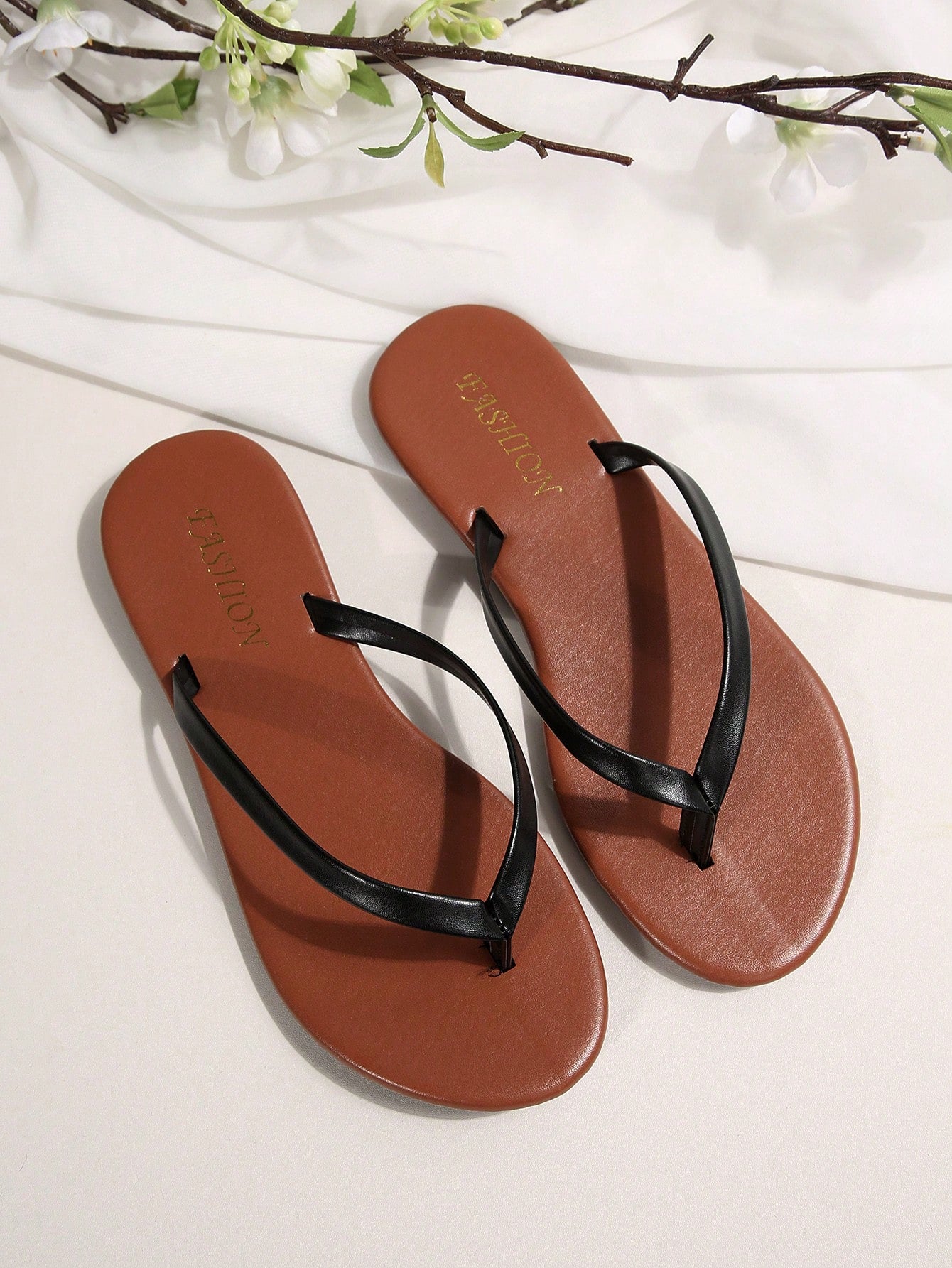 Women's chocolate brown flat flip flop sandals featuring a toe-post thong style and braided detail, suitable for casual indoor and outdoor wear.