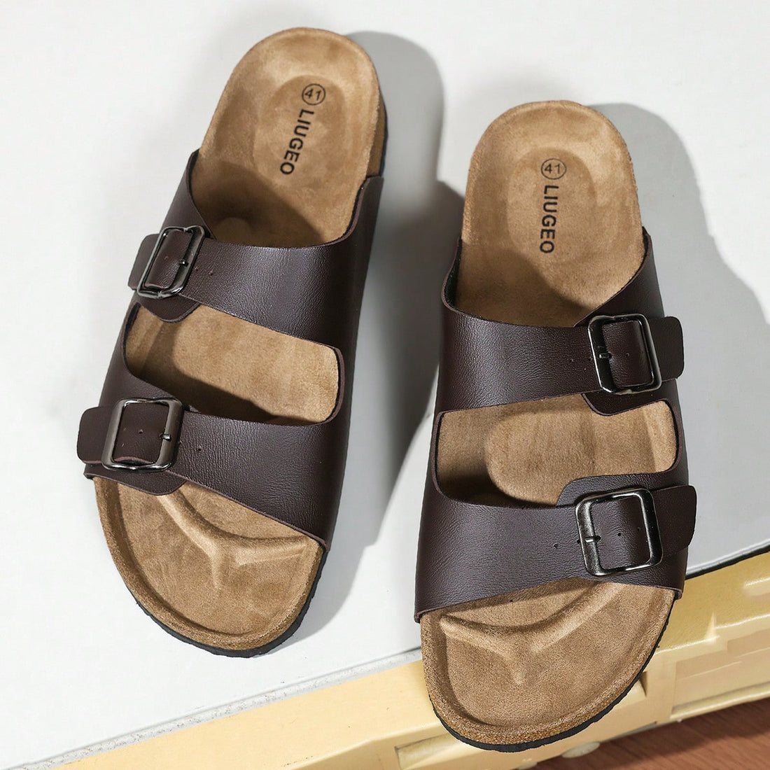 Unisex slip-on footbed slide sandals with adjustable buckle straps, open toe, and flat sole for casual home and outdoor wear.