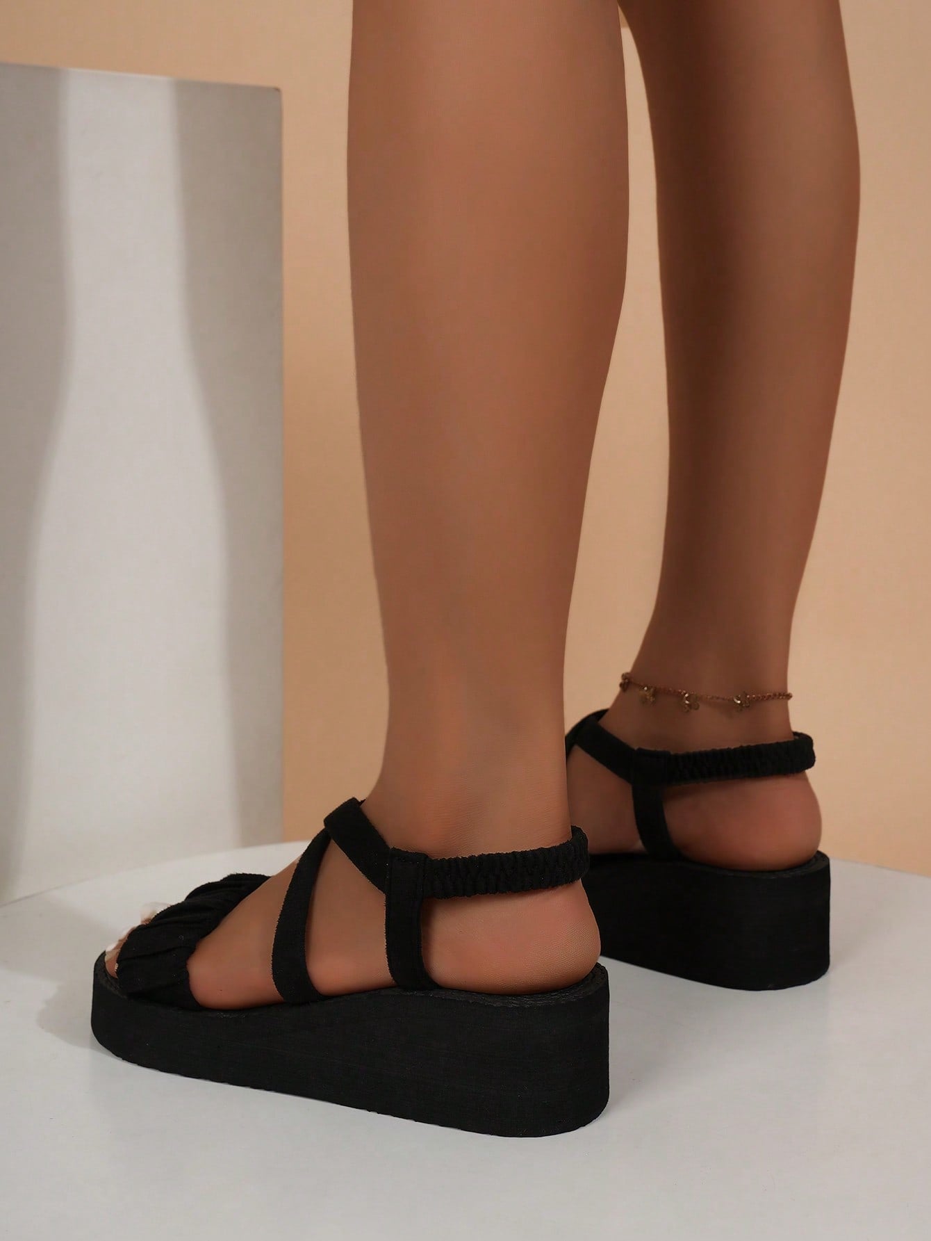 Women's black open-toe slip-on wedge sandals with crisscross back straps and ruched knot-style strap detail, designed in a casual lightweight vacation and street style.