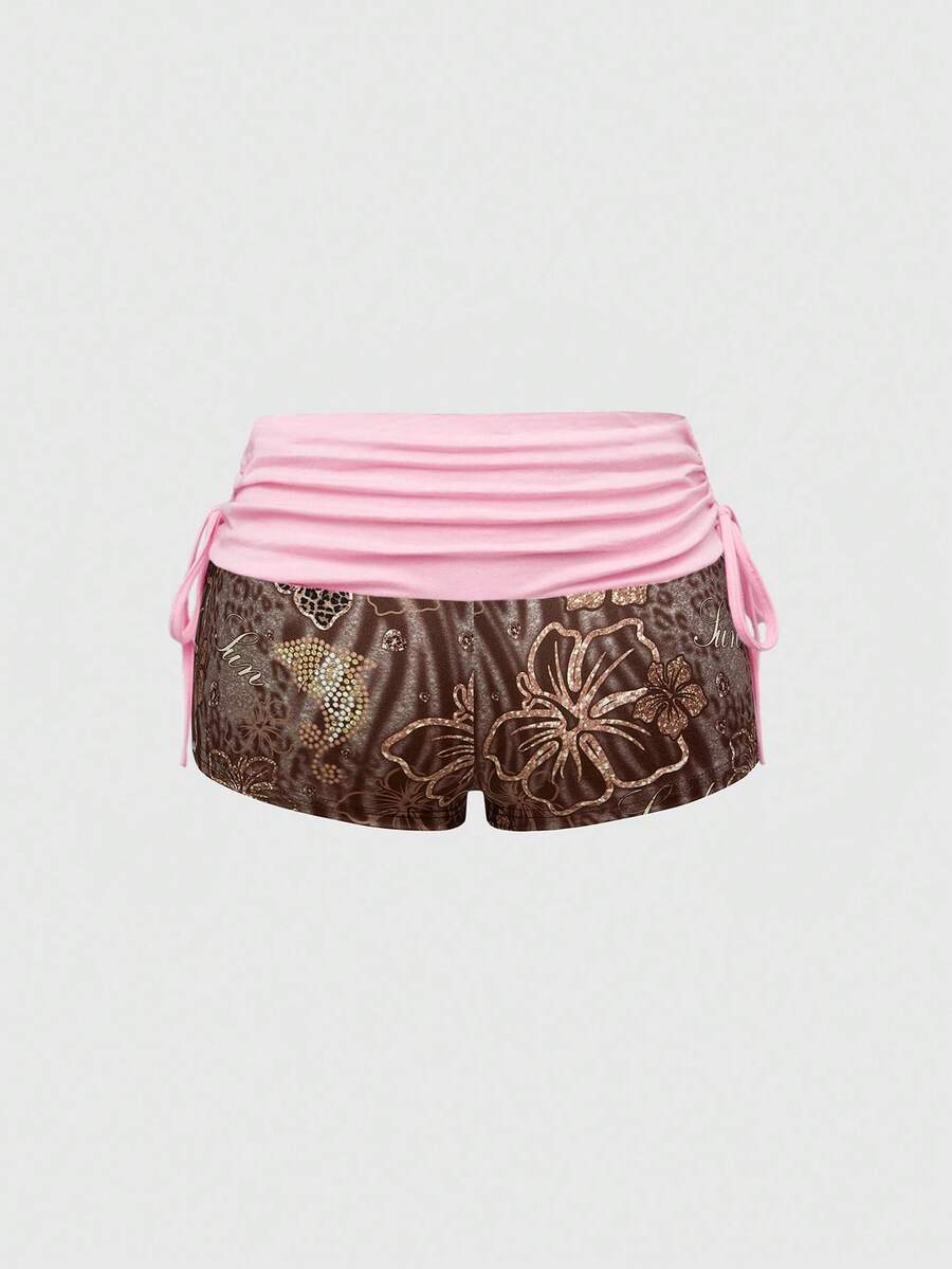 Women's low waist mini track shorts with elastic waistband, drawstring knot, ruched details, and plant pattern in a Y2K boho style