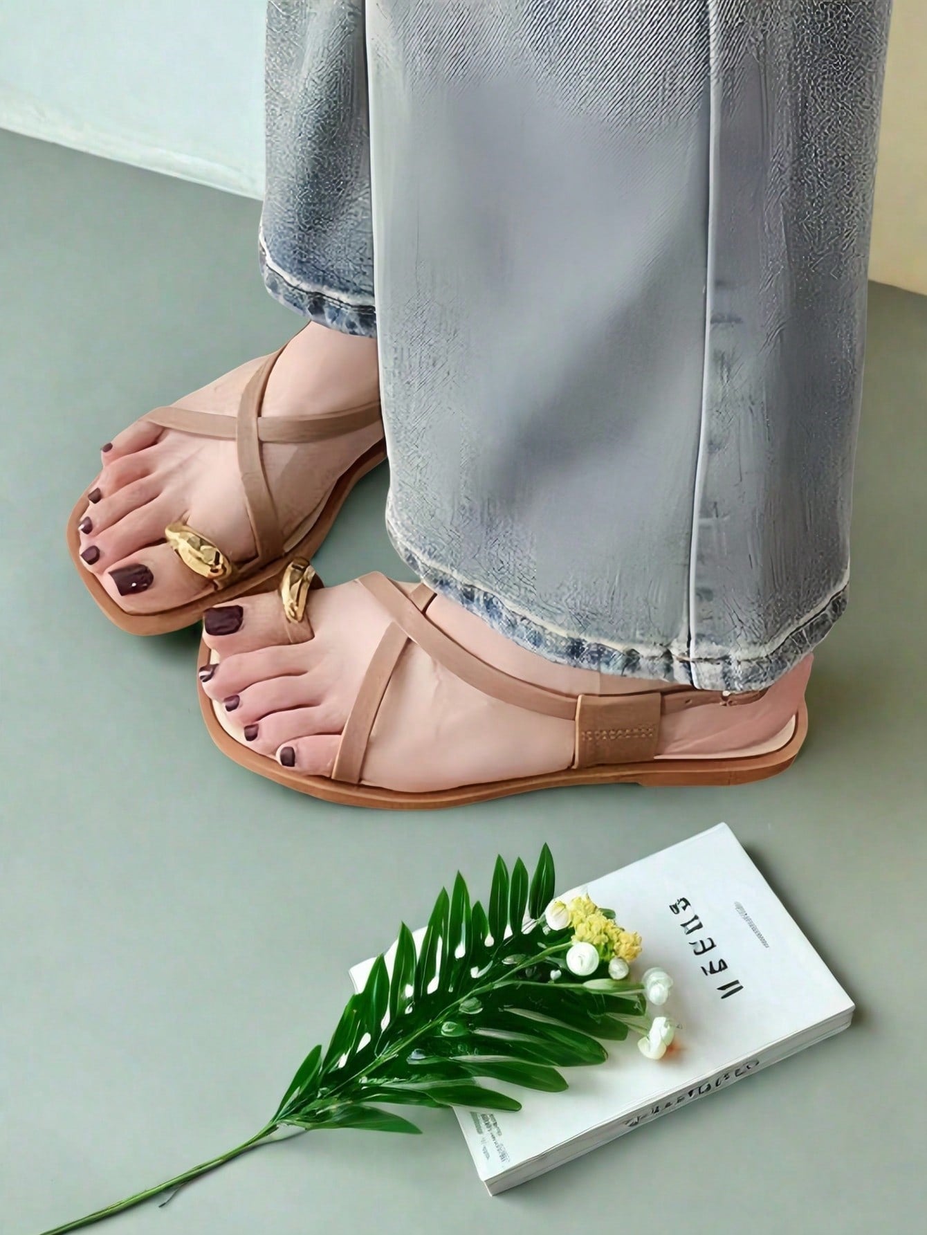 Women's white flat slide sandals featuring criss cross straps, shell detail, and buckle accents