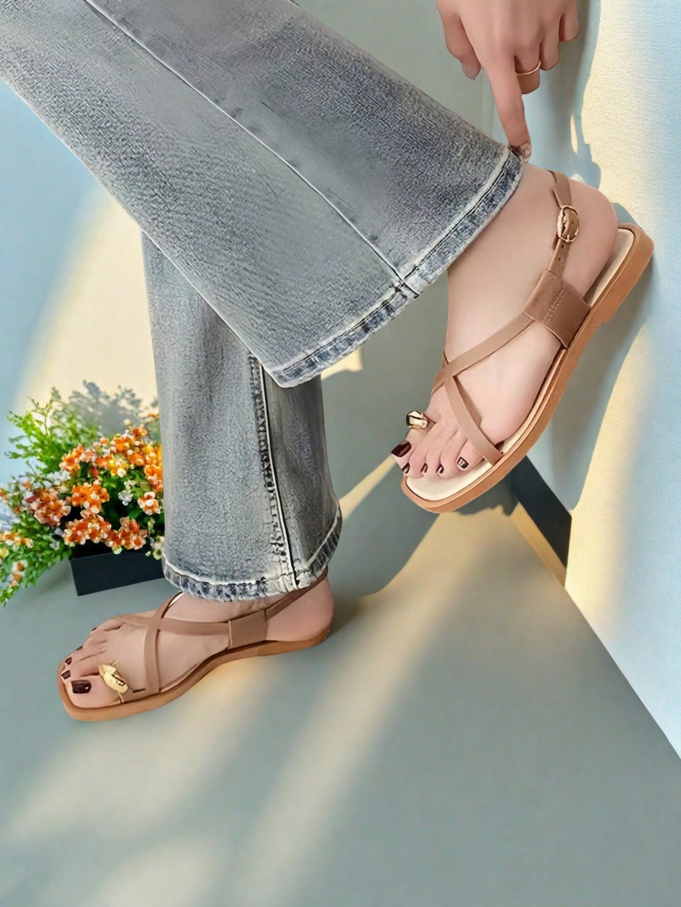 Women's white flat slide sandals featuring criss cross straps, shell detail, and buckle accents