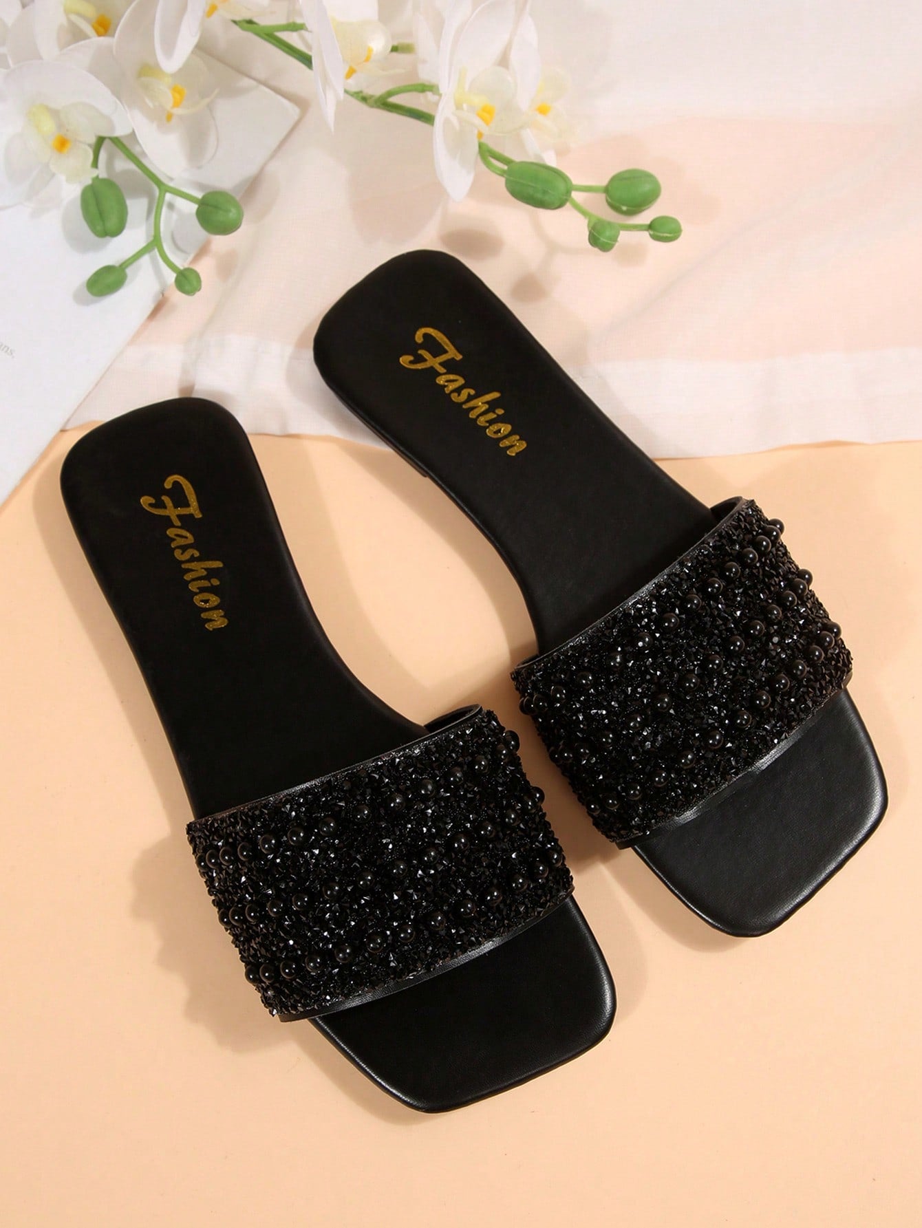 Women's flat slide sandals with rhinestone-decorated straps and open toe, casual outdoor style with plain design.