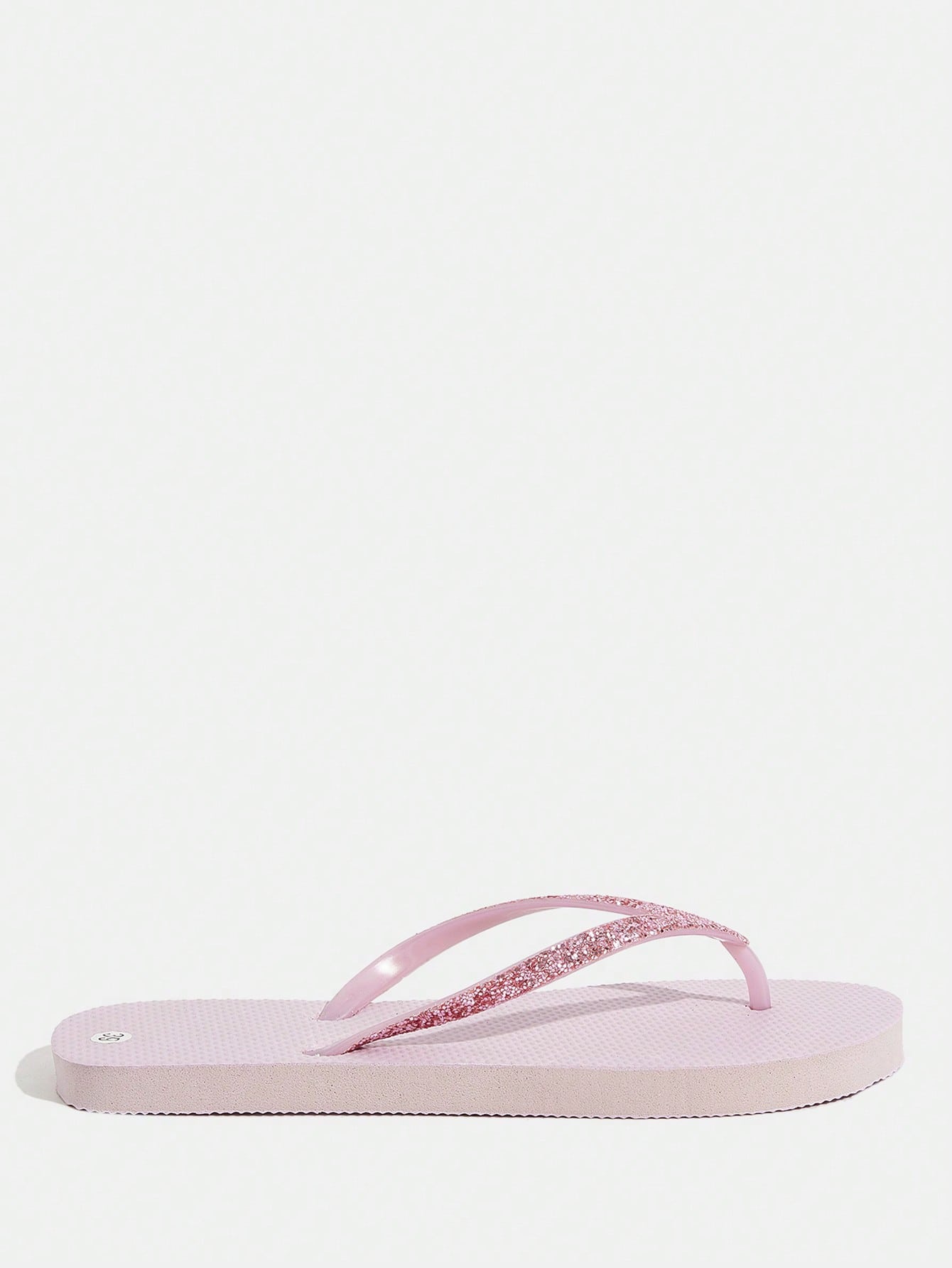 Pair of women’s apricot flat flip-flops with a glitter upper and plain design, suitable for beach, outdoor, home, and vacation wear.