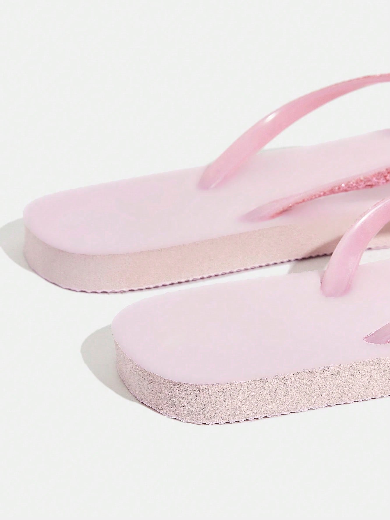 Pair of women’s apricot flat flip-flops with a glitter upper and plain design, suitable for beach, outdoor, home, and vacation wear.