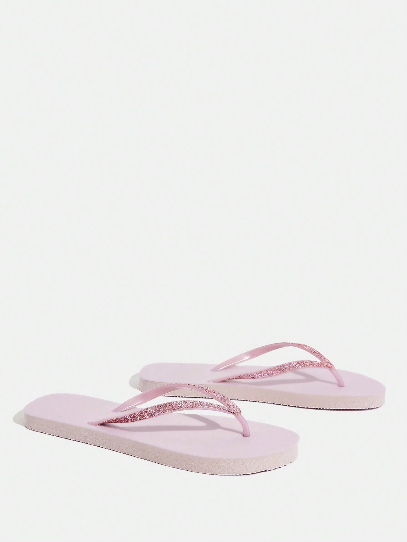 Pair of women’s apricot flat flip-flops with a glitter upper and plain design, suitable for beach, outdoor, home, and vacation wear.