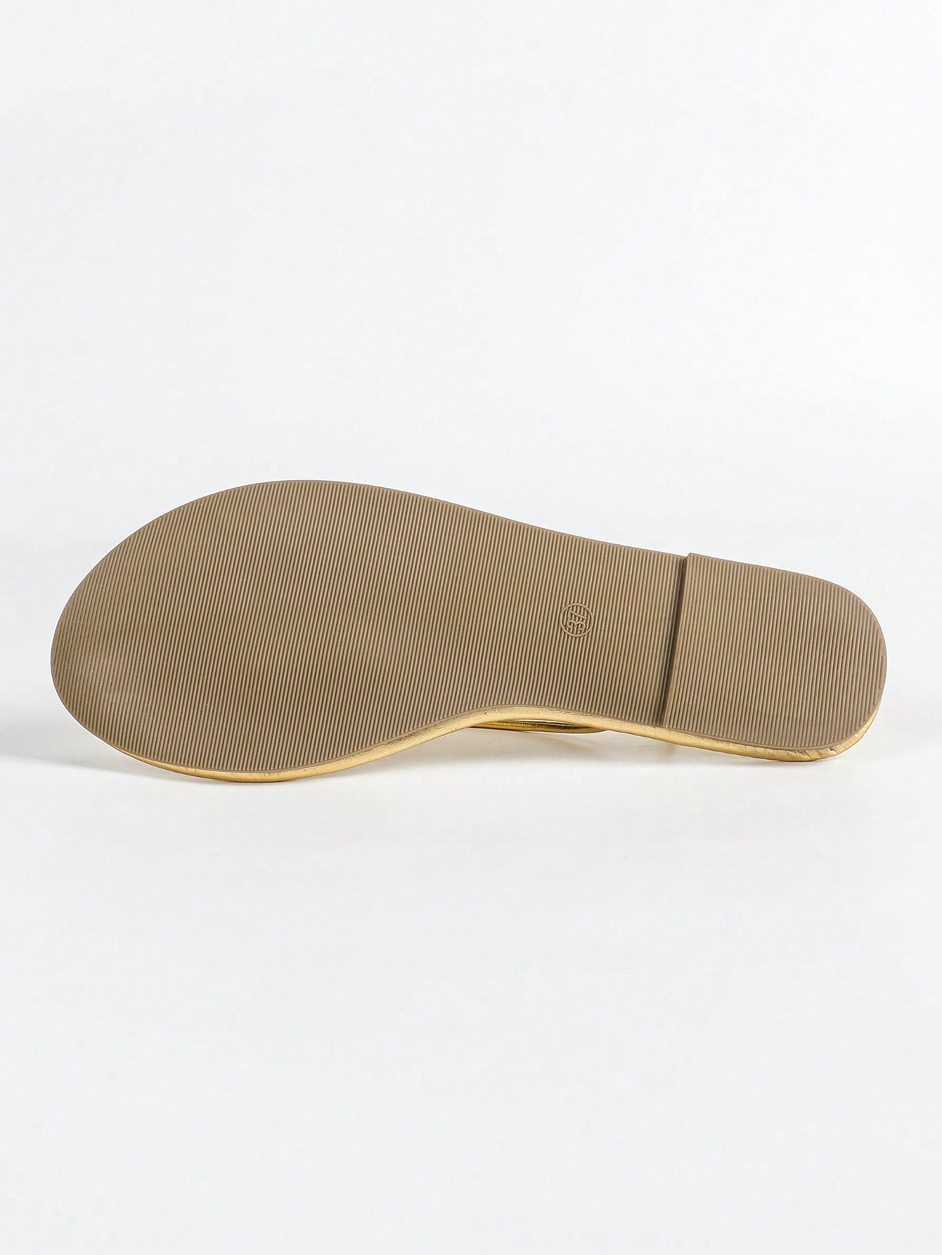 Women's gold flat sandals with metal accent detail, strappy lace-up design, and toe post thong style.