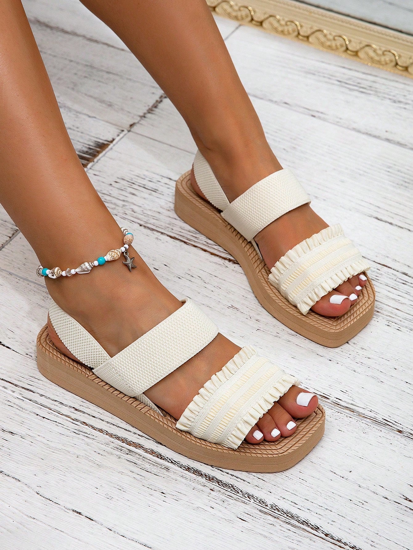 Women's black flat gladiator sandals with ruched and ruffle trim, textured fabric upper, and open-toe design for party, outdoor, and casual wear.