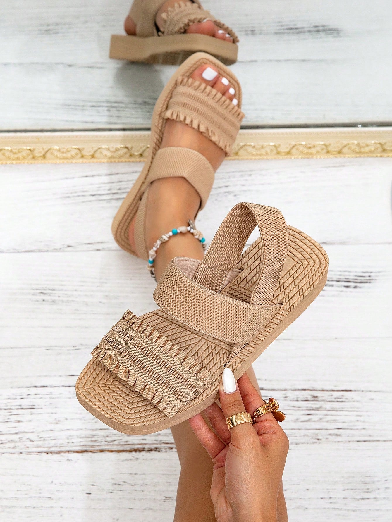 Women's black flat gladiator sandals with ruched and ruffle trim, textured fabric upper, and open-toe design for party, outdoor, and casual wear.