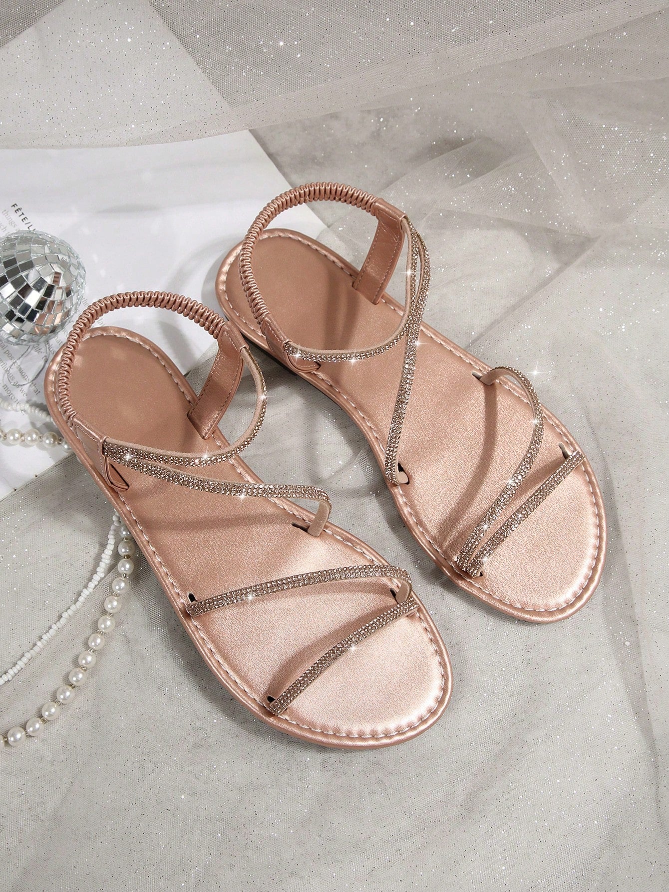 Women's flat sandals with rhinestone strap detail, elastic back, and open round toe in slide style for outdoor or beach wear.