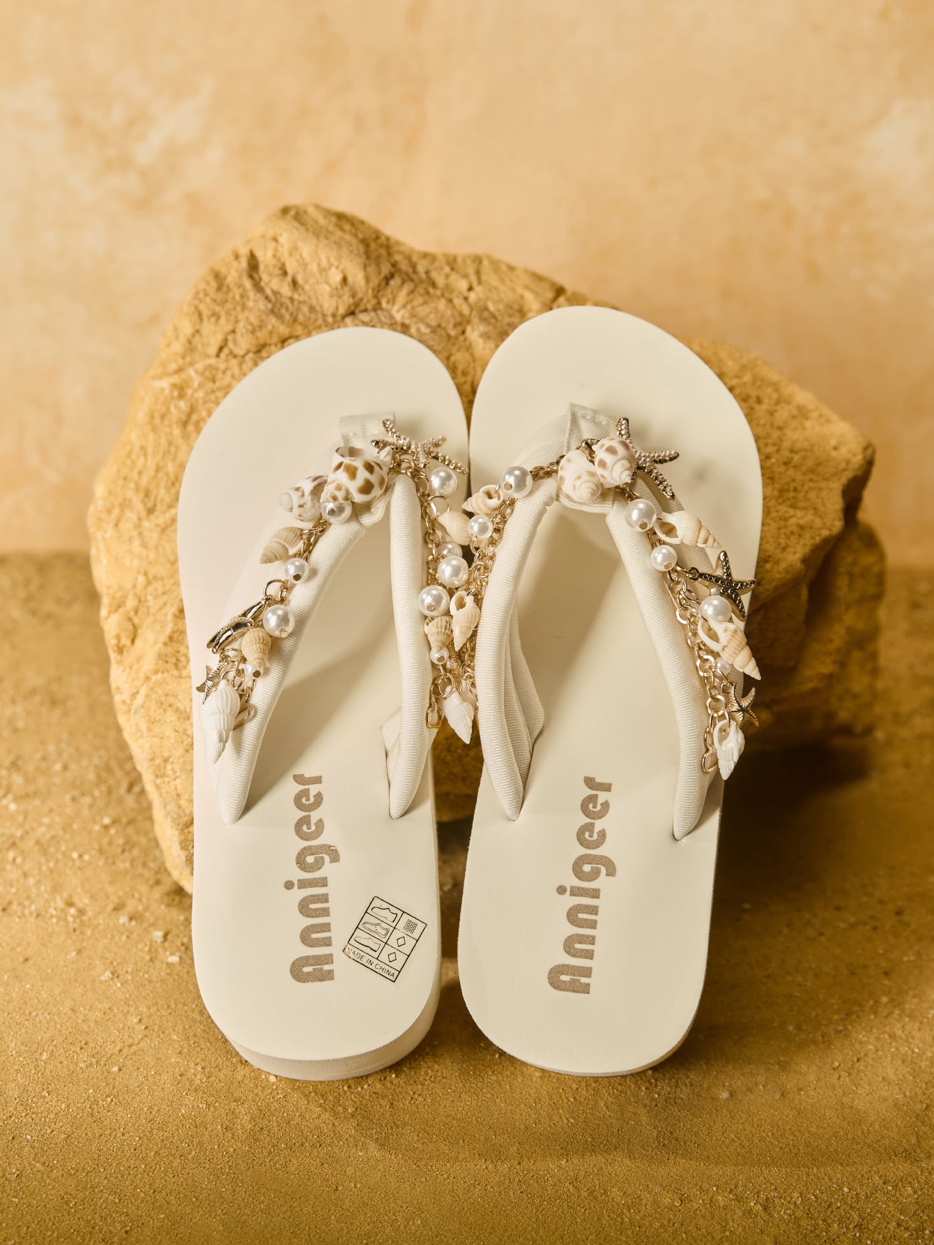 Beige women’s platform wedge slip-on sandals with toe post design, shell chain decoration, and plant pattern detail.