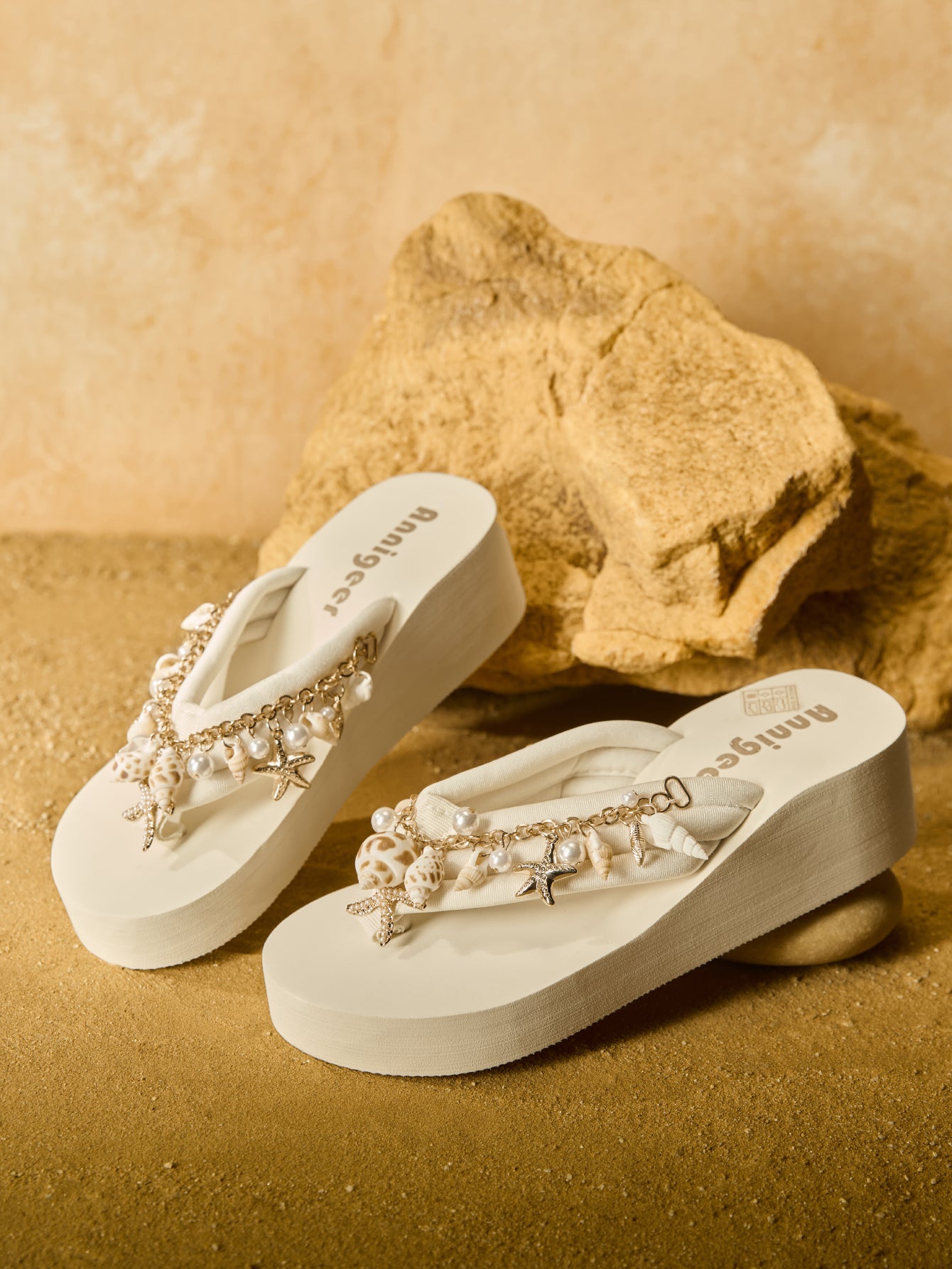 Beige women’s platform wedge slip-on sandals with toe post design, shell chain decoration, and plant pattern detail.