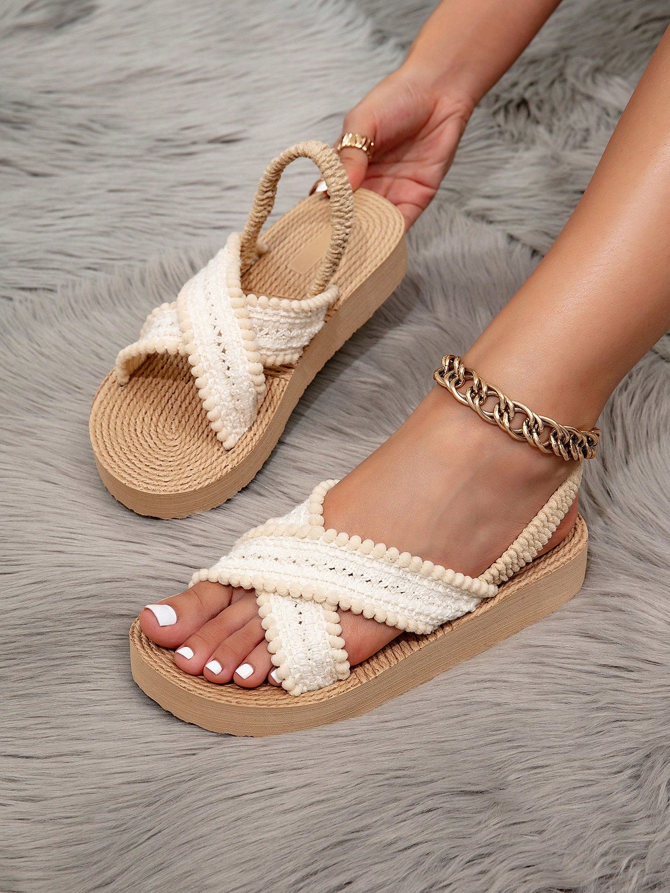 Women's open toe slip-on wedge sandals with criss cross straps and folk-custom styling, featuring raw hem, fringe, tassel, braid, and tape details.