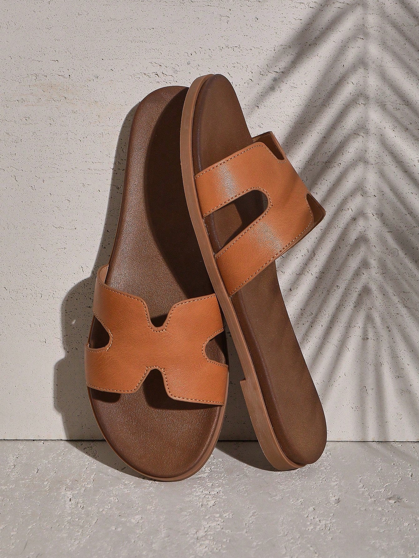 Women's flat slide sandals with supportive PU midsole, harness-style cutout detail, and open toe design.