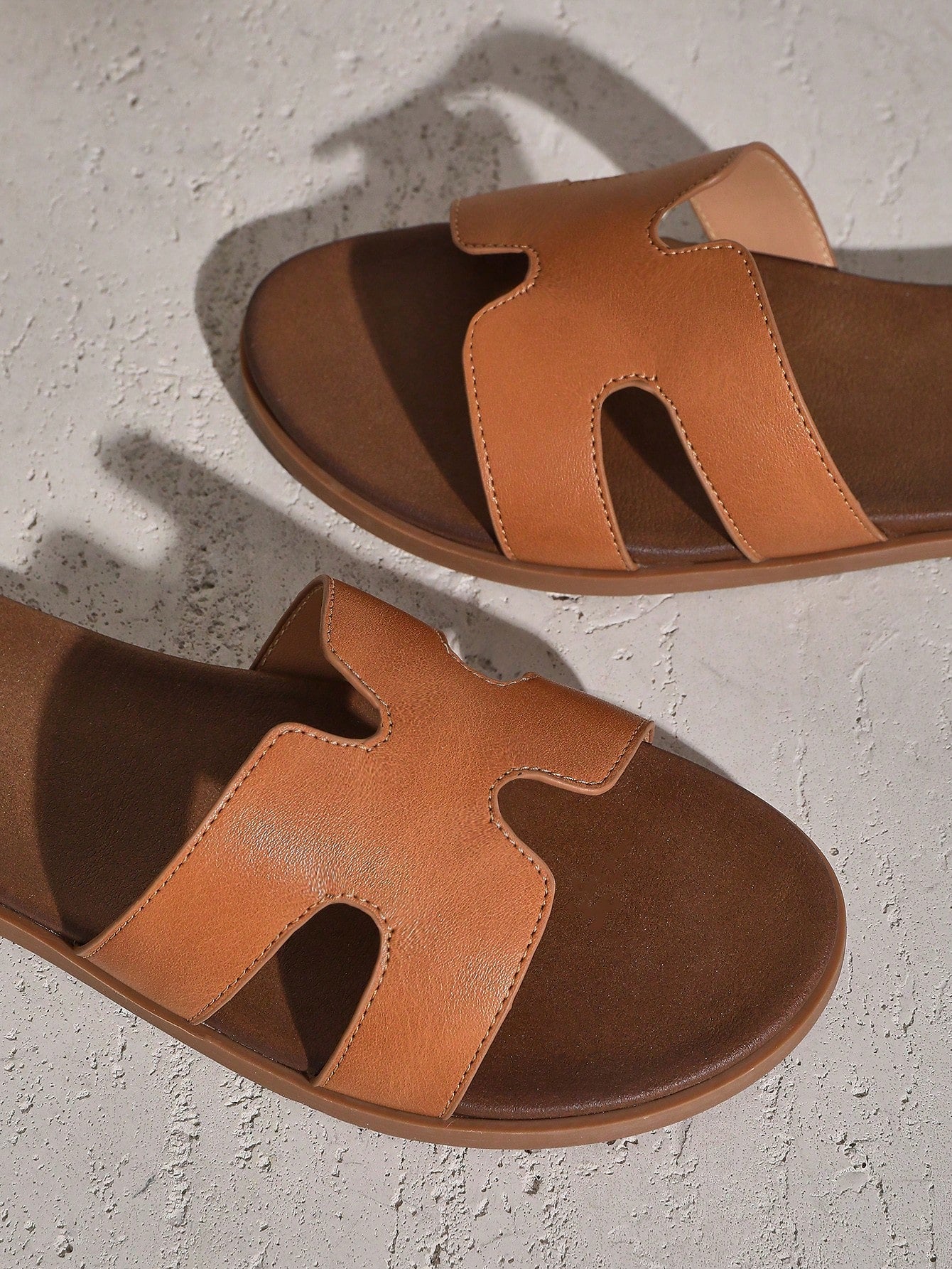 Women's flat slide sandals with supportive PU midsole, harness-style cutout detail, and open toe design.