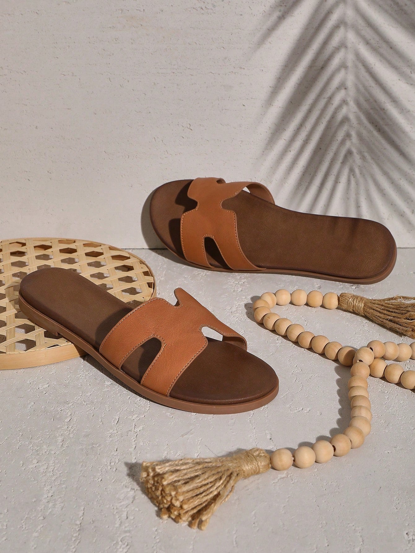 Women's flat slide sandals with supportive PU midsole, harness-style cutout detail, and open toe design.