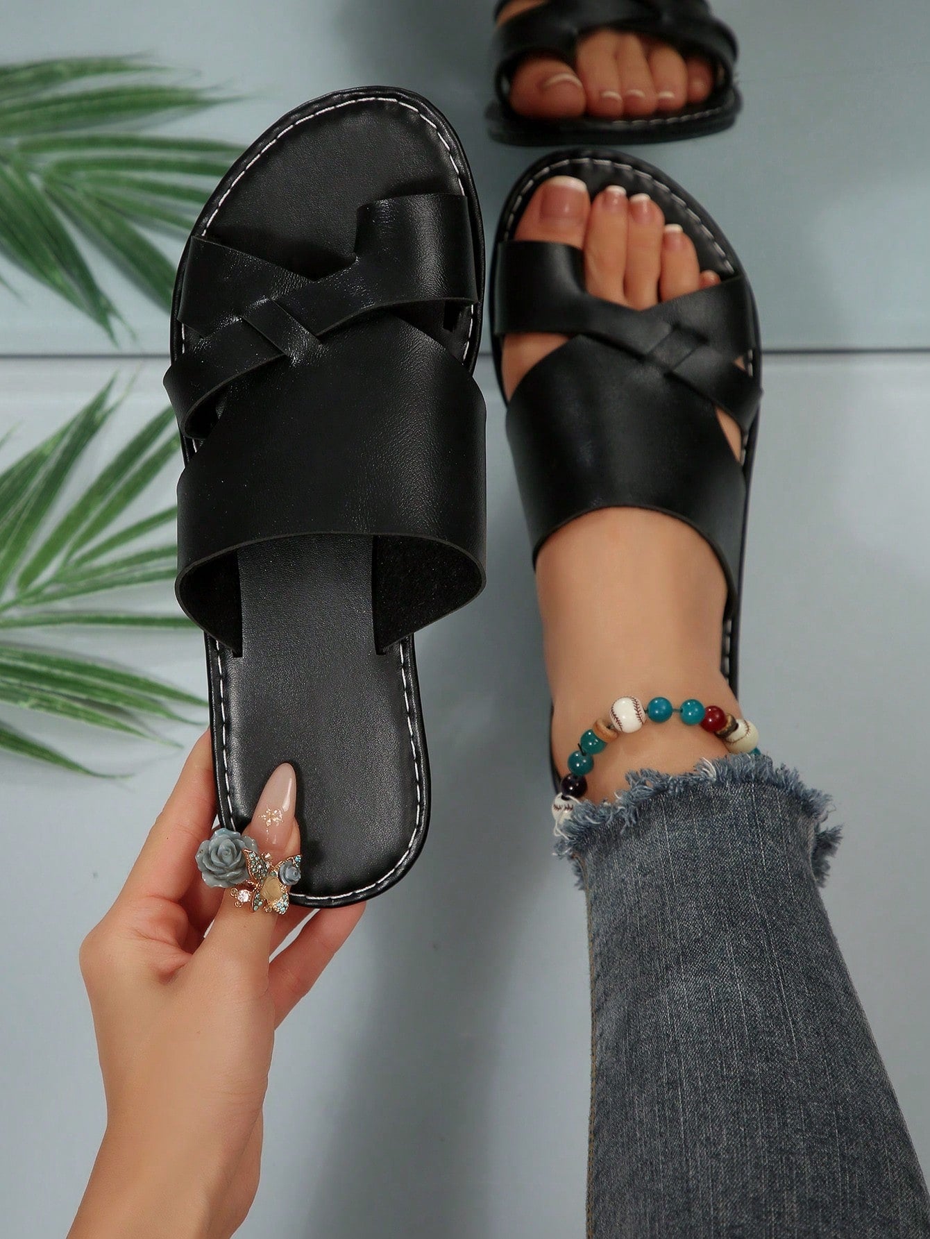 Women’s plus size flat slide sandals with toe-post front and cross-over patchwork upper, designed for casual outdoor and vacation wear.