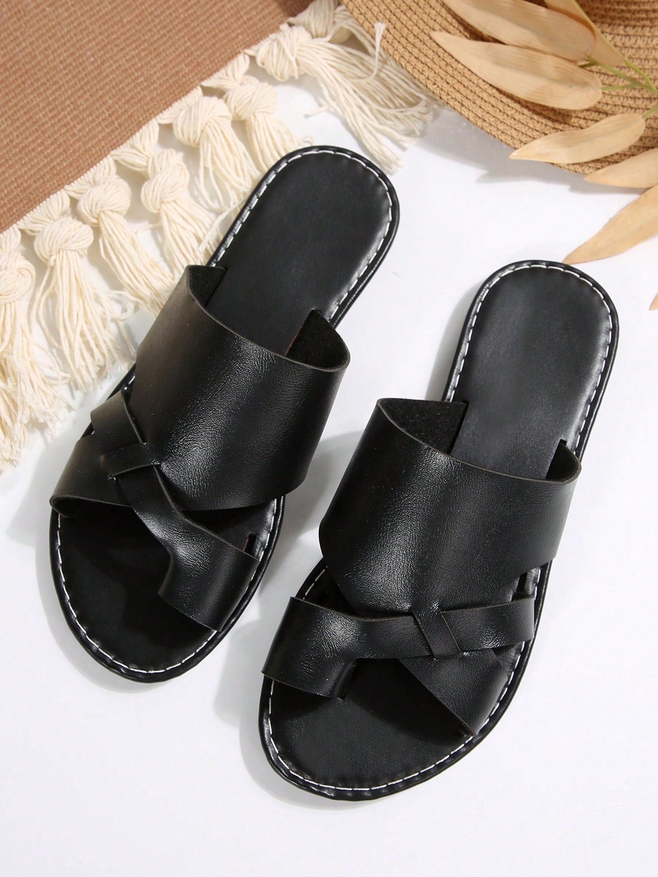 Women’s plus size flat slide sandals with toe-post front and cross-over patchwork upper, designed for casual outdoor and vacation wear.
