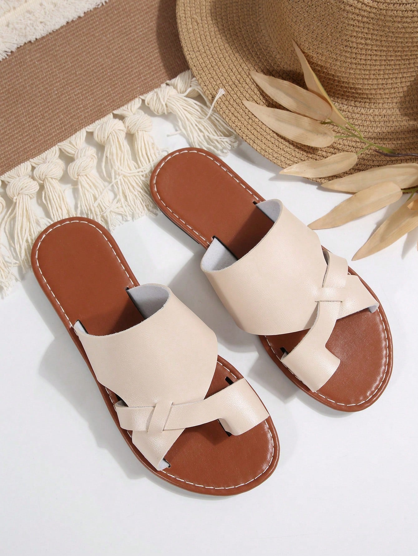 Women’s plus size flat slide sandals with toe-post front and cross-over patchwork upper, designed for casual outdoor and vacation wear.