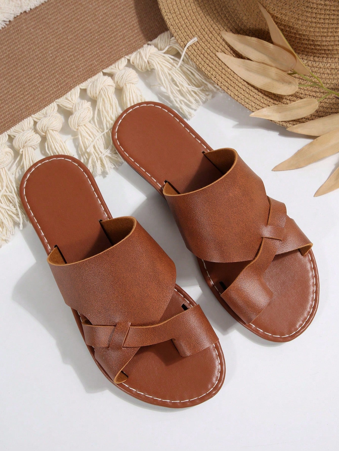 Women’s plus size flat slide sandals with toe-post front and cross-over patchwork upper, designed for casual outdoor and vacation wear.