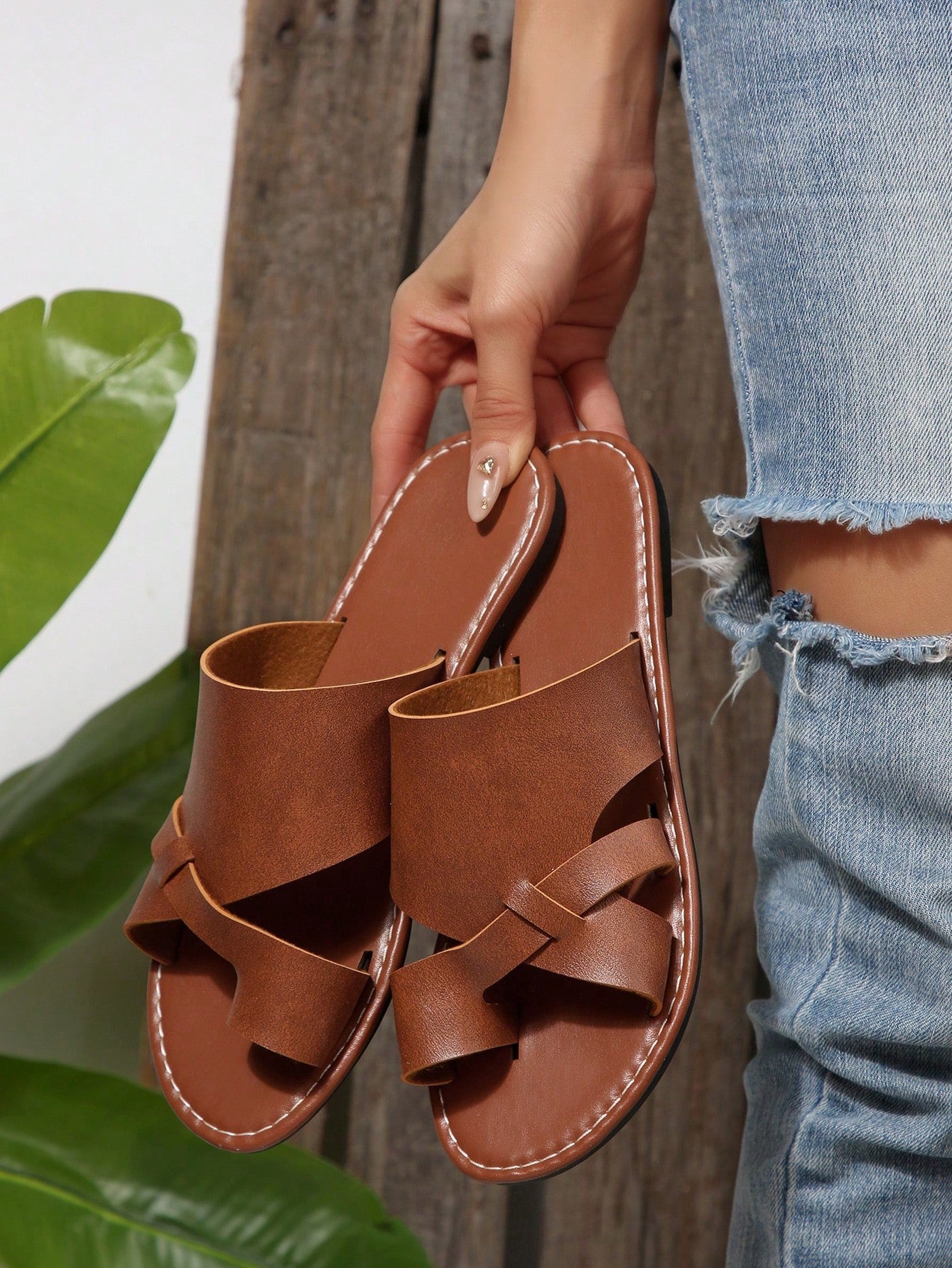 Women’s plus size flat slide sandals with toe-post front and cross-over patchwork upper, designed for casual outdoor and vacation wear.