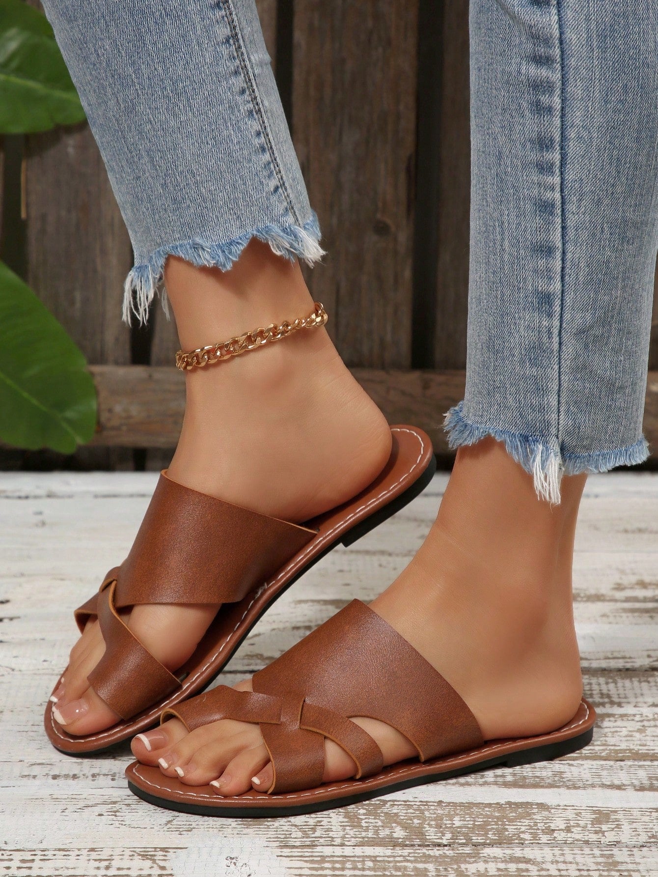 Women’s plus size flat slide sandals with toe-post front and cross-over patchwork upper, designed for casual outdoor and vacation wear.