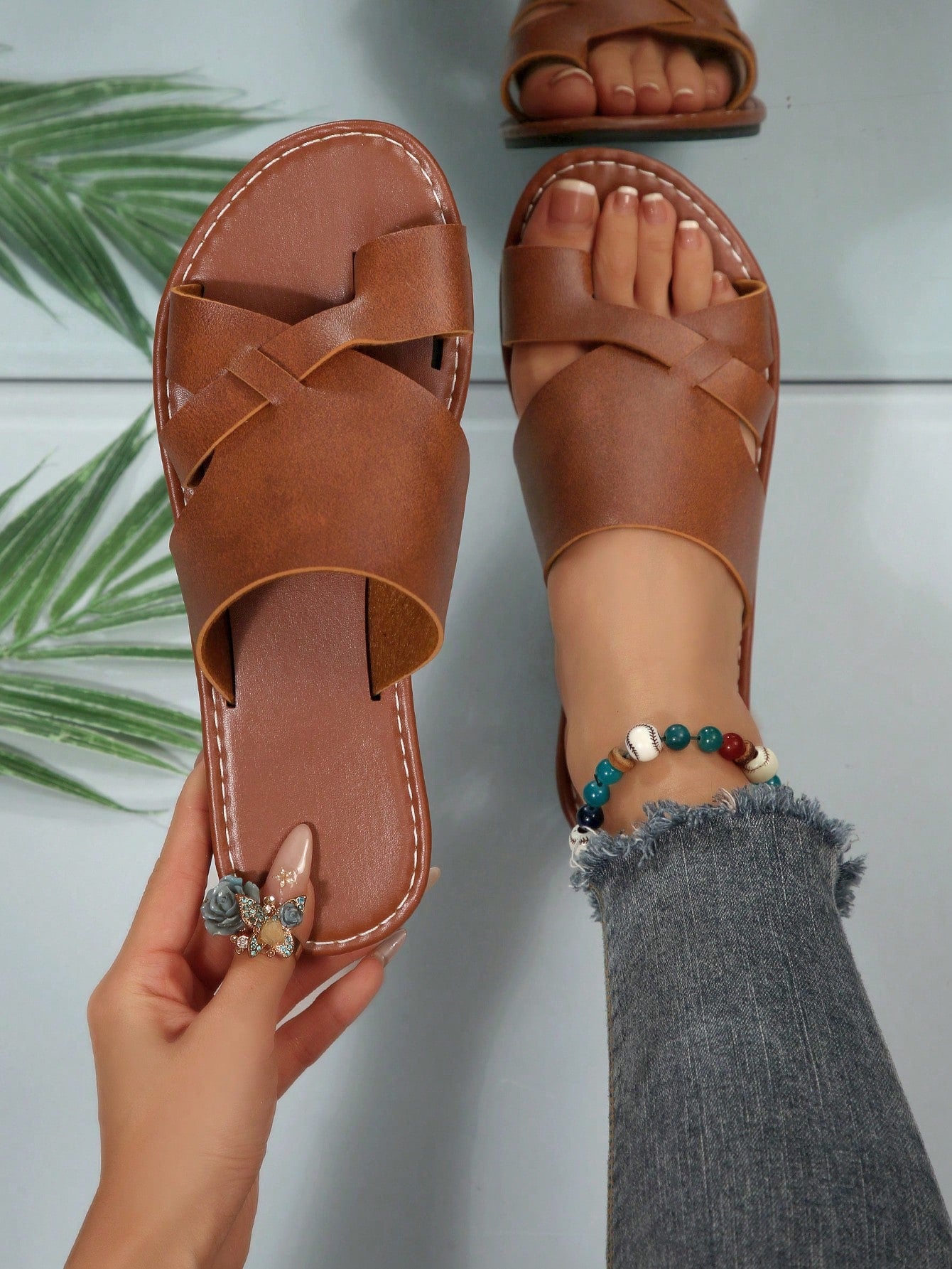 Women’s plus size flat slide sandals with toe-post front and cross-over patchwork upper, designed for casual outdoor and vacation wear.