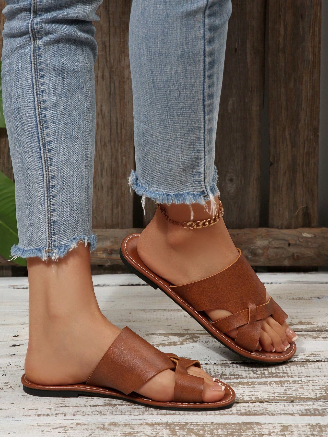 Women’s plus size flat slide sandals with toe-post front and cross-over patchwork upper, designed for casual outdoor and vacation wear.