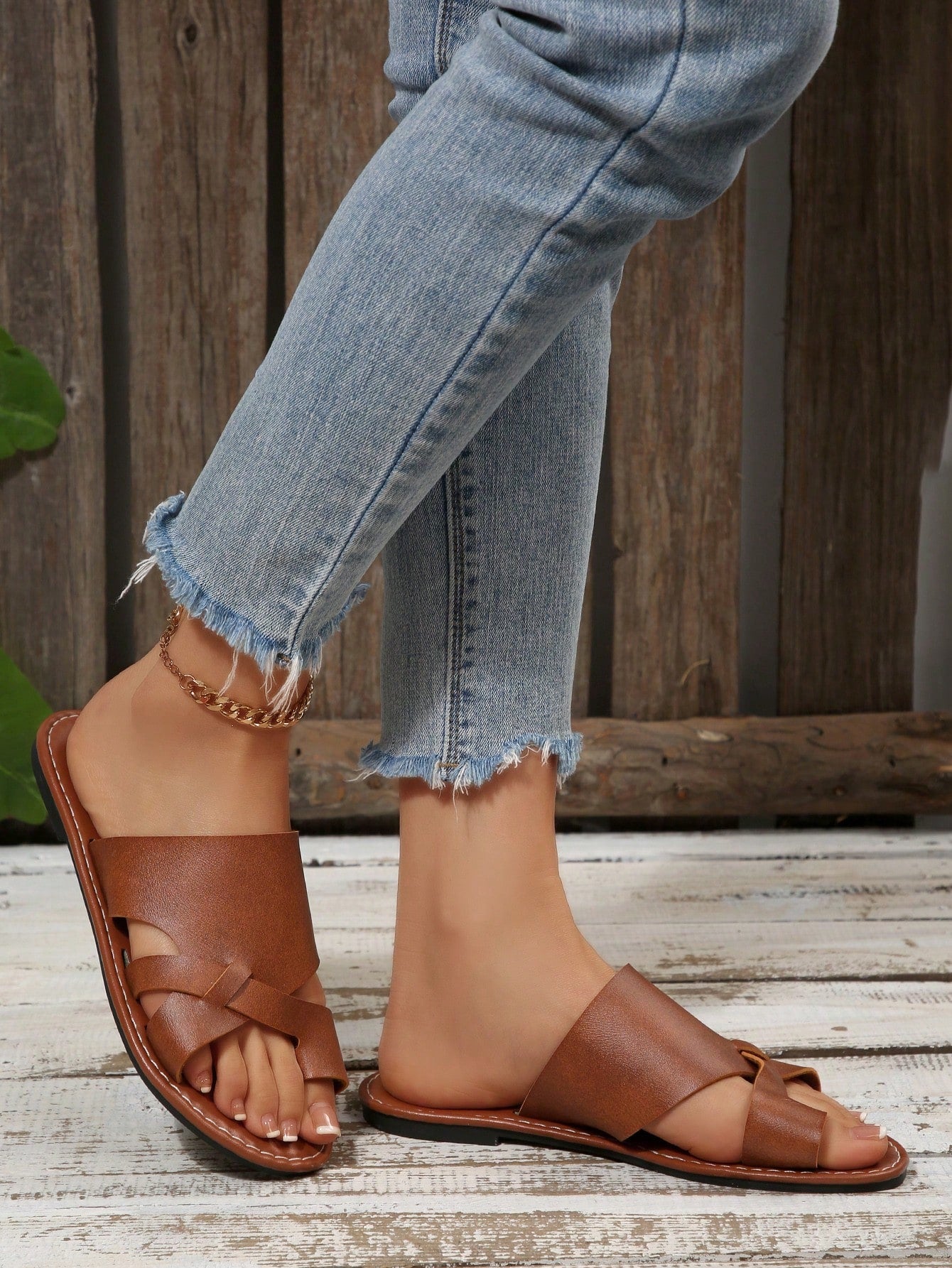 Women’s plus size flat slide sandals with toe-post front and cross-over patchwork upper, designed for casual outdoor and vacation wear.