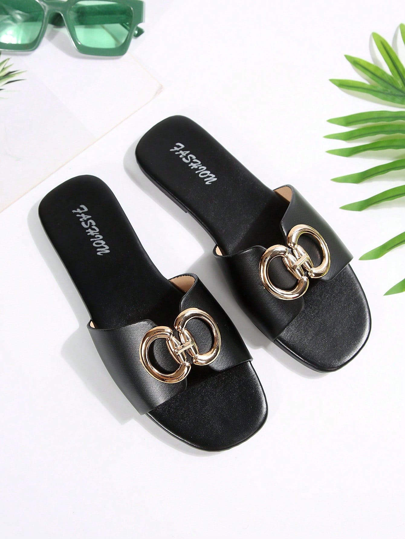 Women's gold-tone slip-on slide sandals with open toe and chain link detailing, shown as casual flat sandals for indoor and outdoor use.