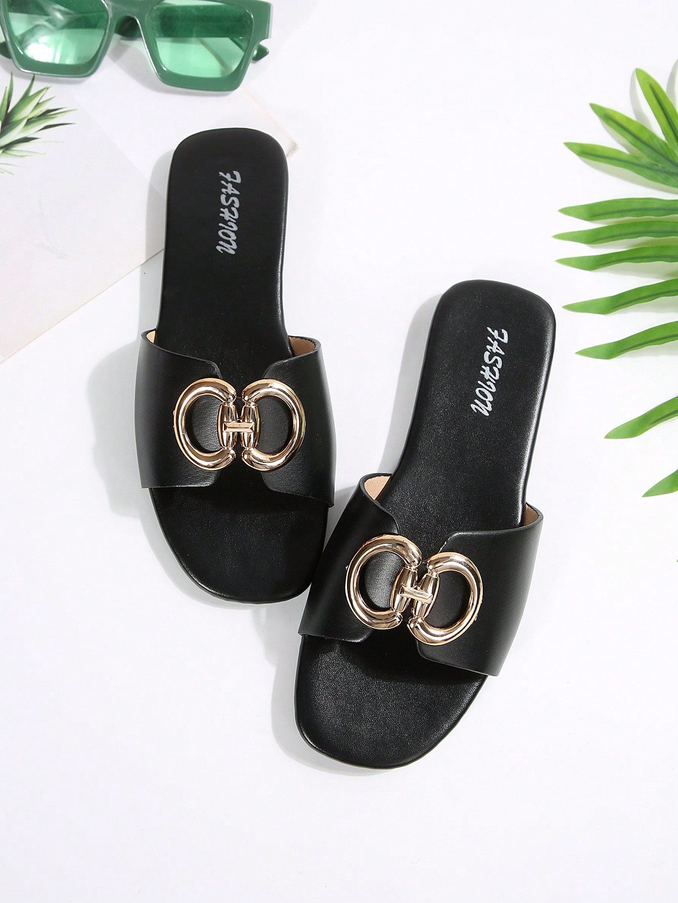 Women's gold-tone slip-on slide sandals with open toe and chain link detailing, shown as casual flat sandals for indoor and outdoor use.