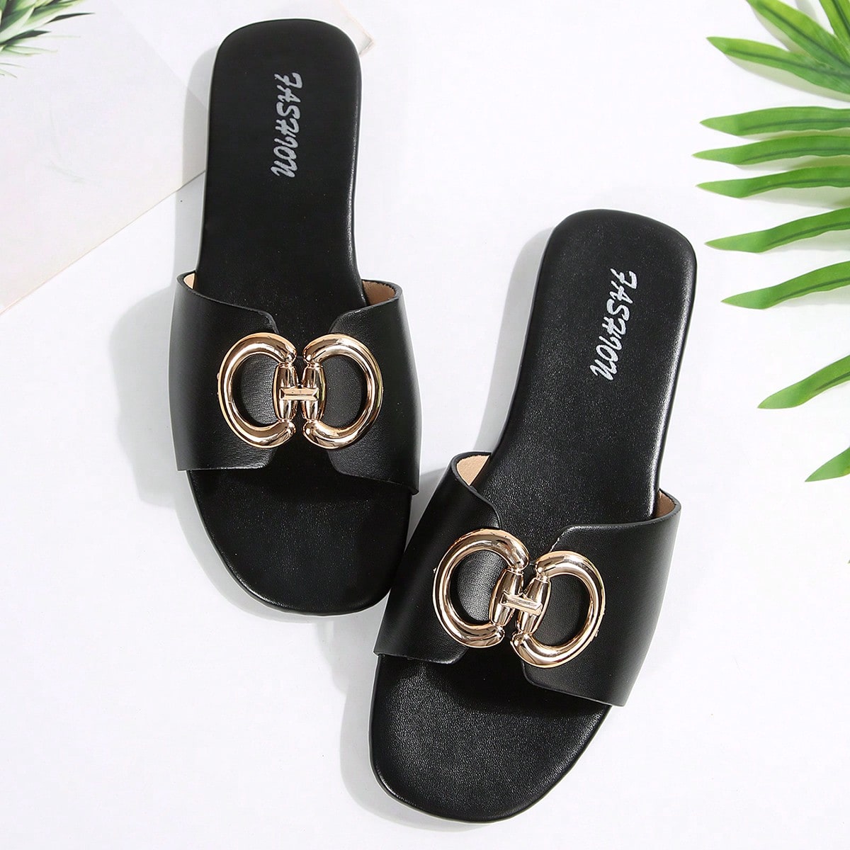 Women's gold-tone slip-on slide sandals with open toe and chain link detailing, shown as casual flat sandals for indoor and outdoor use.