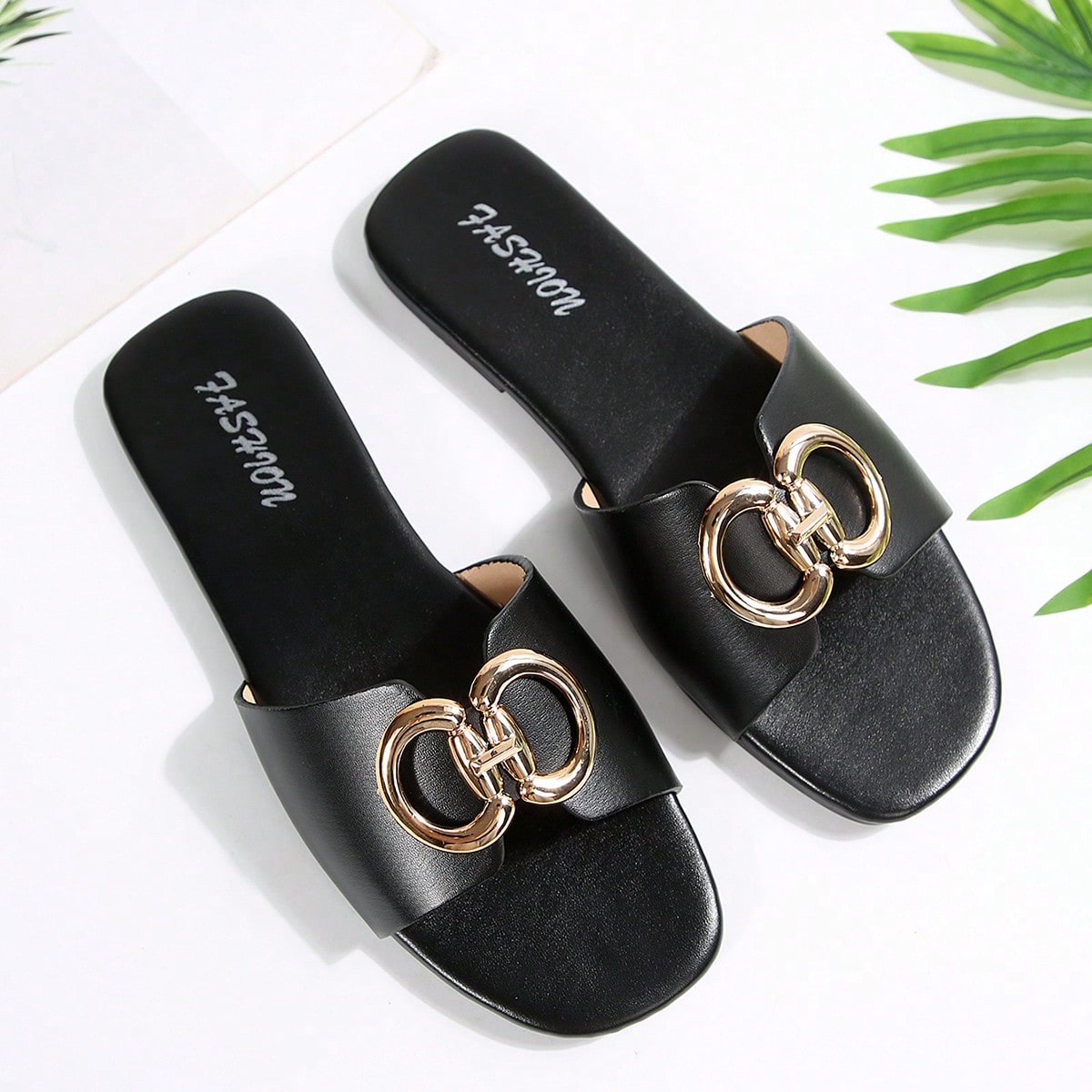 Women's gold-tone slip-on slide sandals with open toe and chain link detailing, shown as casual flat sandals for indoor and outdoor use.