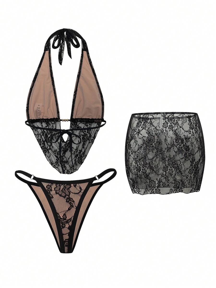 Women's black 3-piece bikini set with halter triangle top, backless design, ruched thong bottoms, and matching lace skirt for beach or vacation wear.