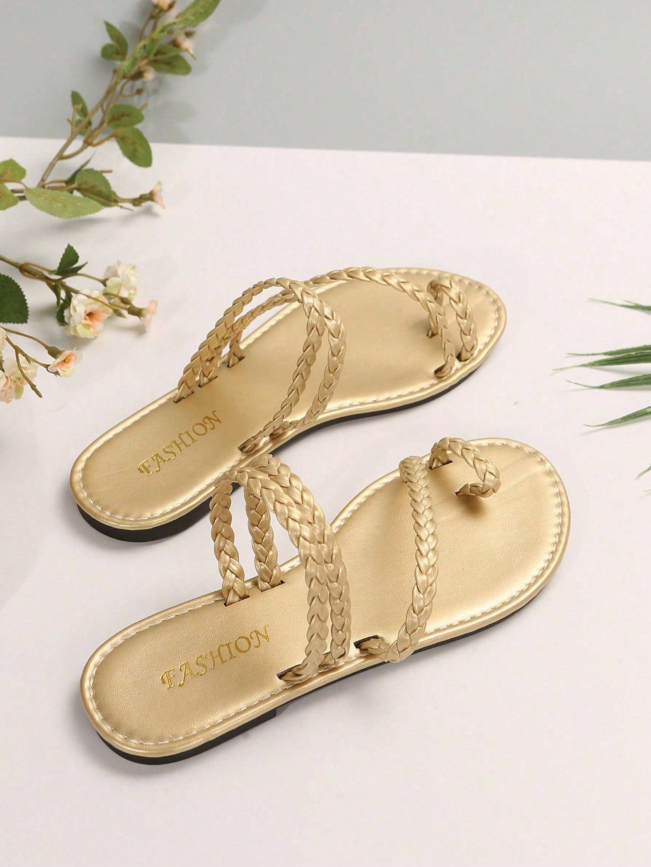 Plus size women's flat slide sandals with woven braid detail and open toe, casual outdoor beach and vacation style.