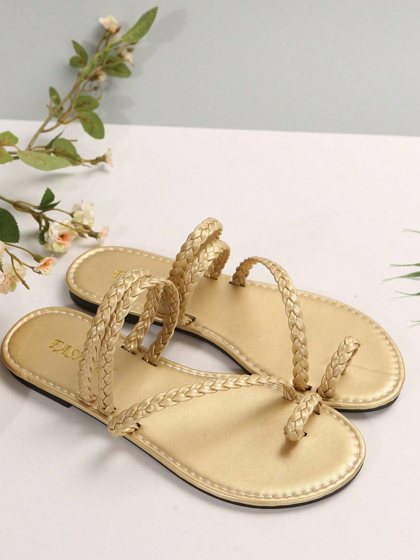 Plus size women's flat slide sandals with woven braid detail and open toe, casual outdoor beach and vacation style.