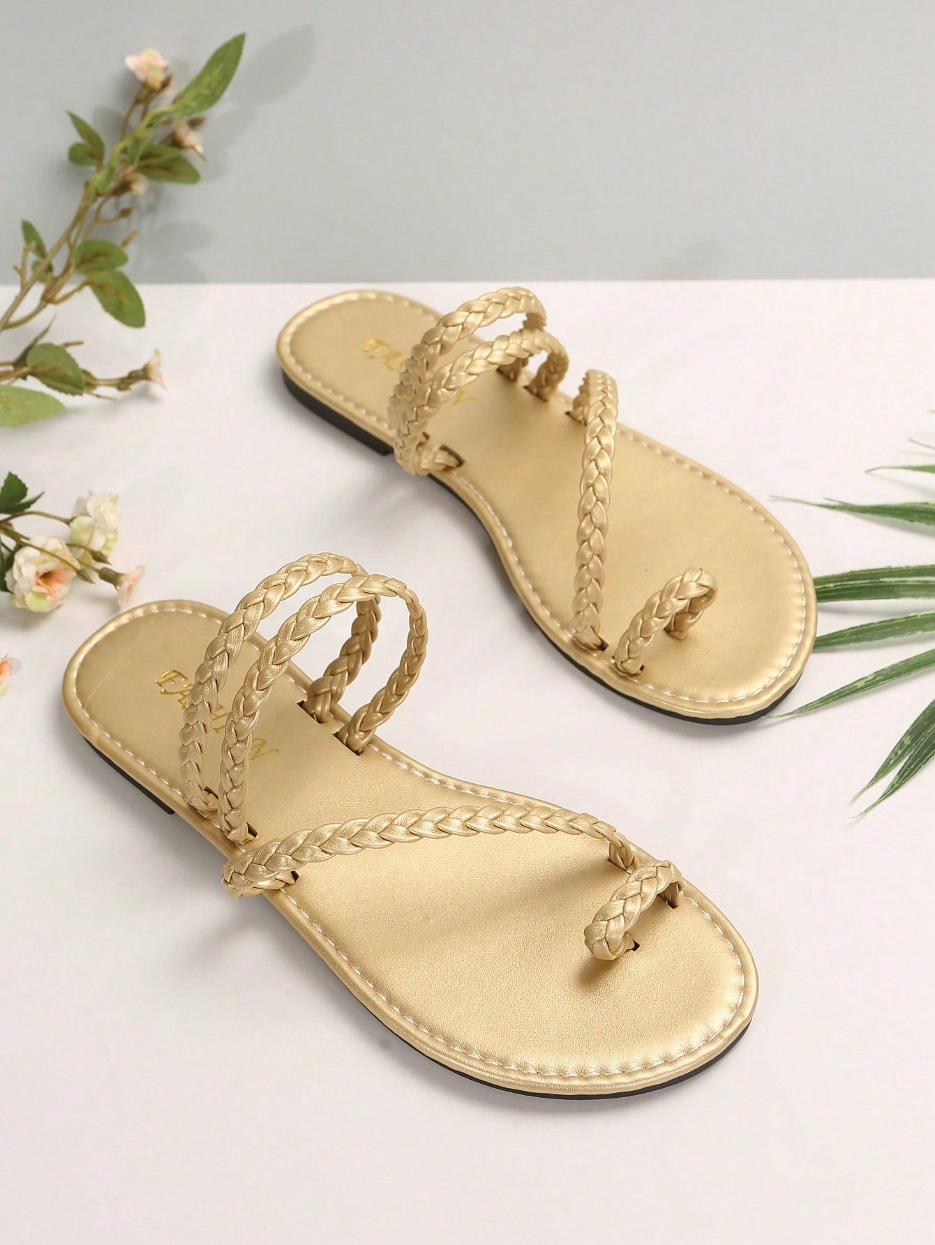 Plus size women's flat slide sandals with woven braid detail and open toe, casual outdoor beach and vacation style.