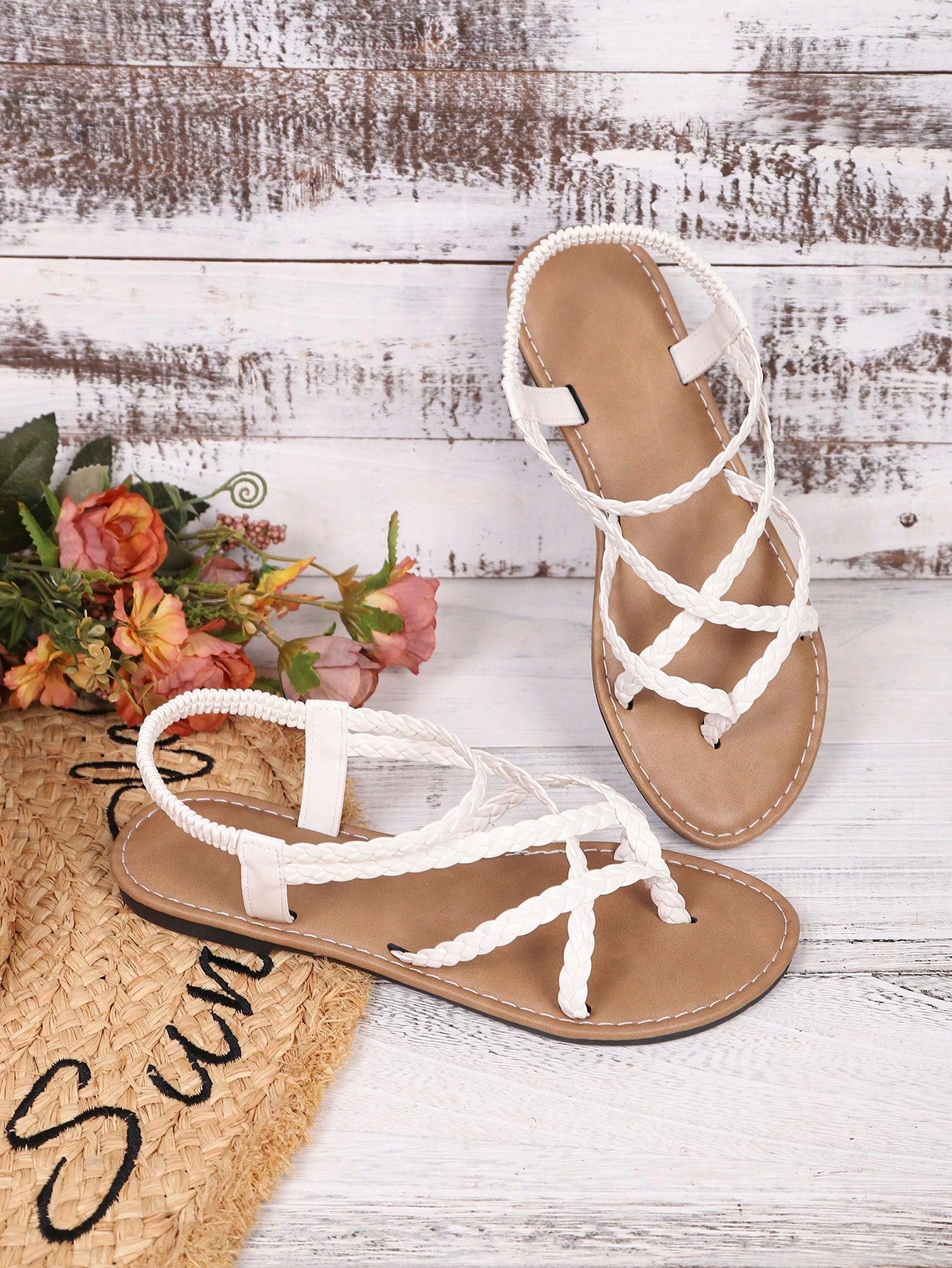 Women's woven criss-cross elastic flat sandals with braided strappy upper and toe post design