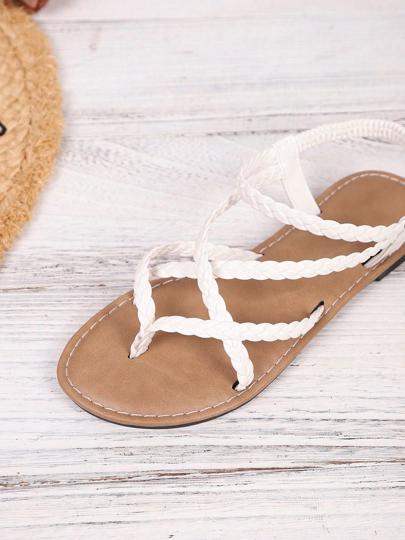 Women's woven criss-cross elastic flat sandals with braided strappy upper and toe post design