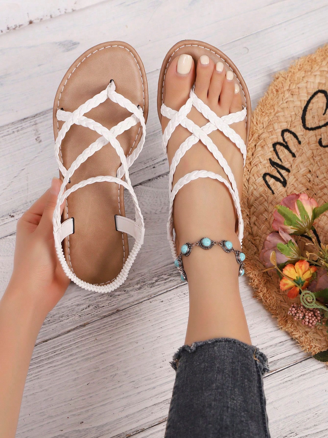 Women's woven criss-cross elastic flat sandals with braided strappy upper and toe post design