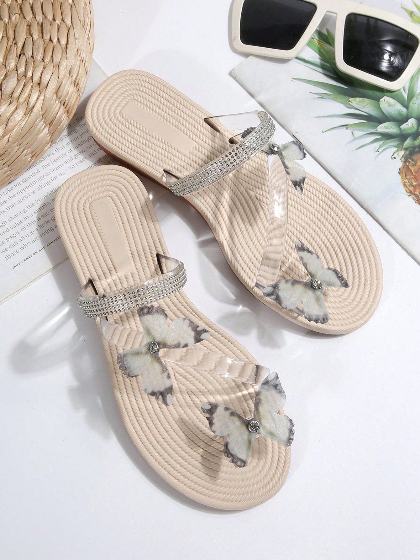 Women's open-toe strappy flat sandals with tasseled upper, seashell-inspired decoration, and rhinestone detail, designed for lightweight, comfortable beach and casual indoor or outdoor wear.