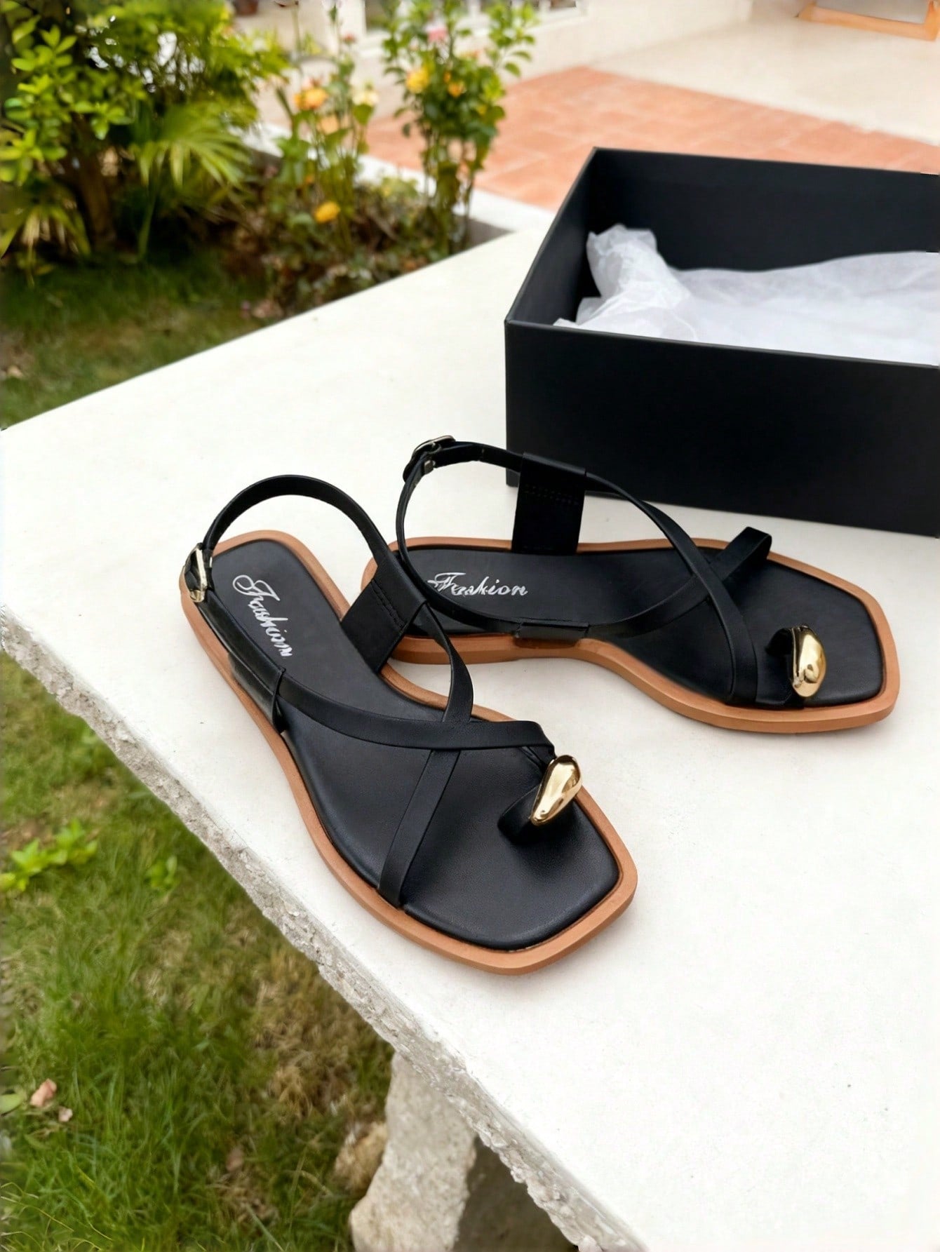 Women's white flat slide sandals featuring criss cross straps, shell detail, and buckle accents